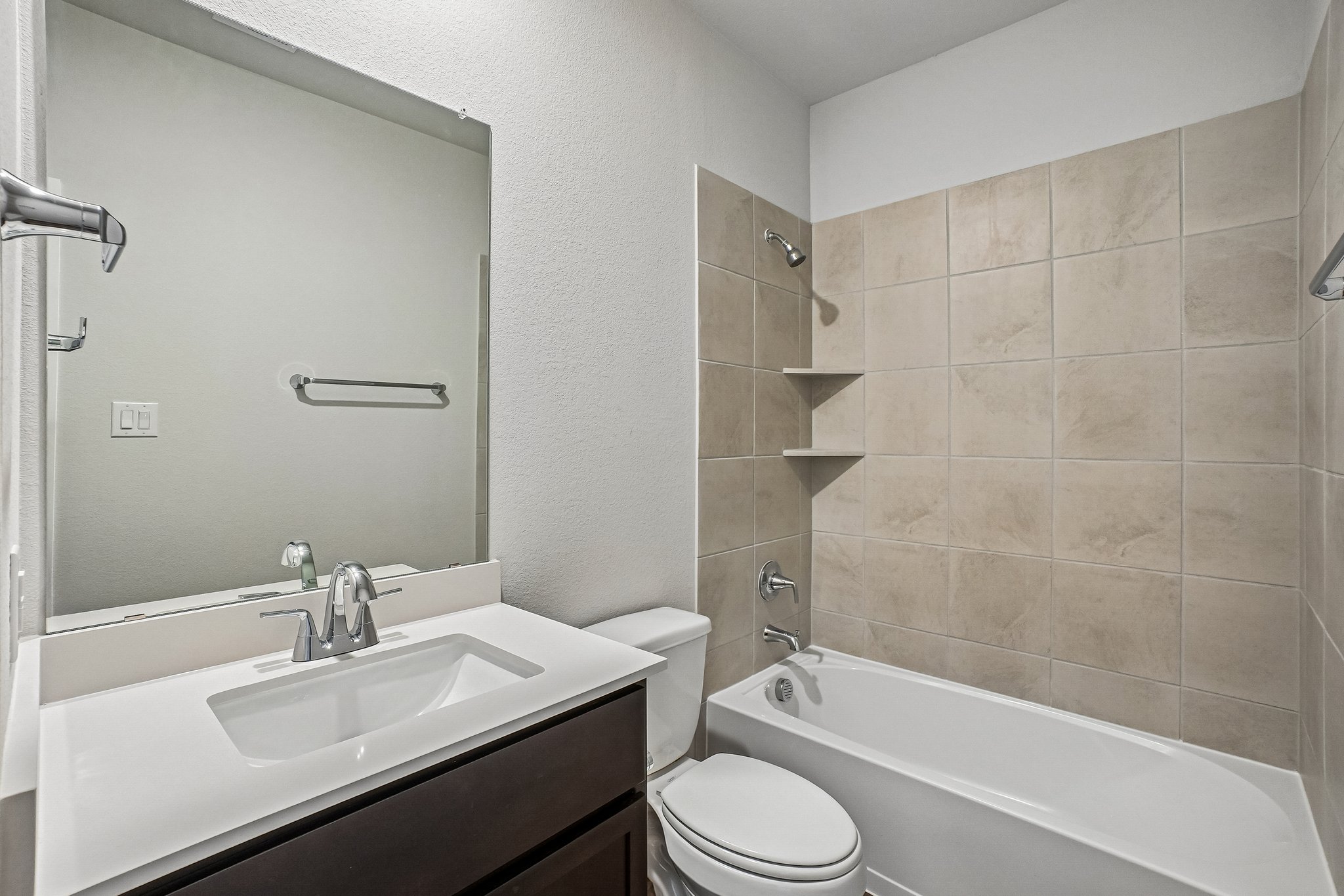 A bathroom with a sink toilet and bathtub.