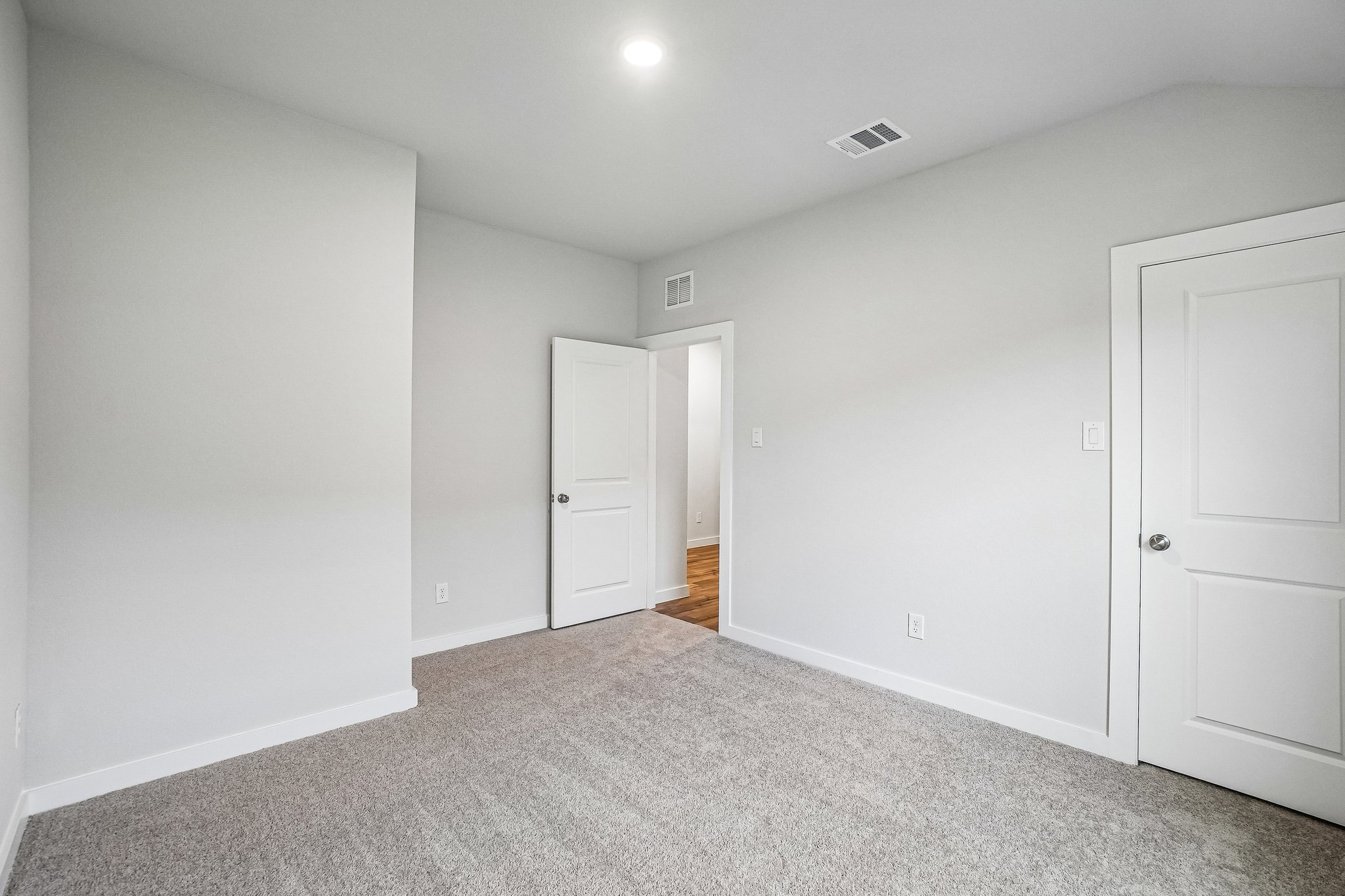 A hallway with white doors.