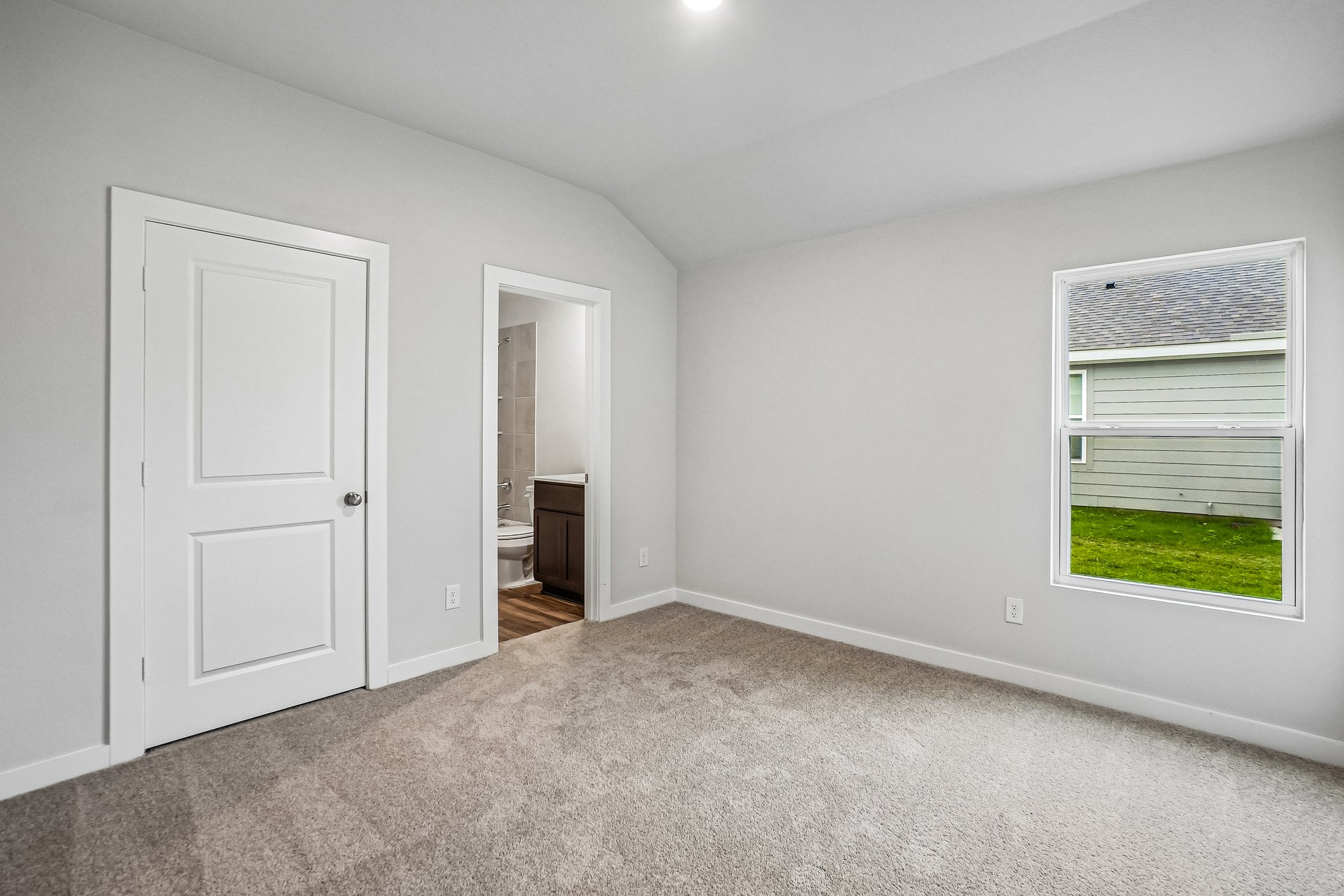 A room with white walls and a door.