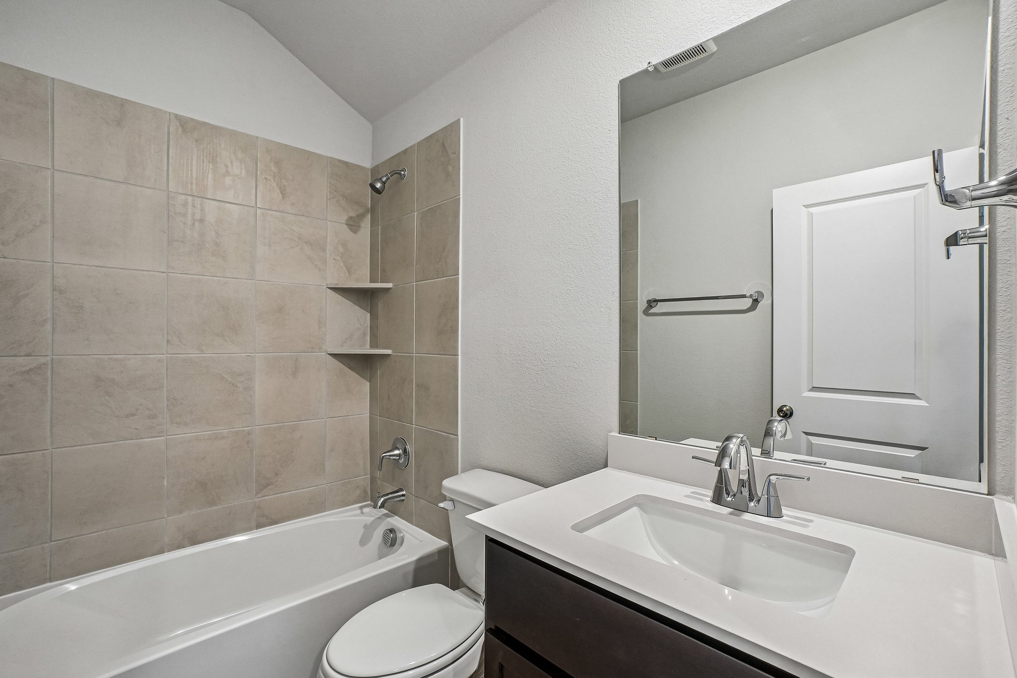 A bathroom with a sink toilet and bathtub.
