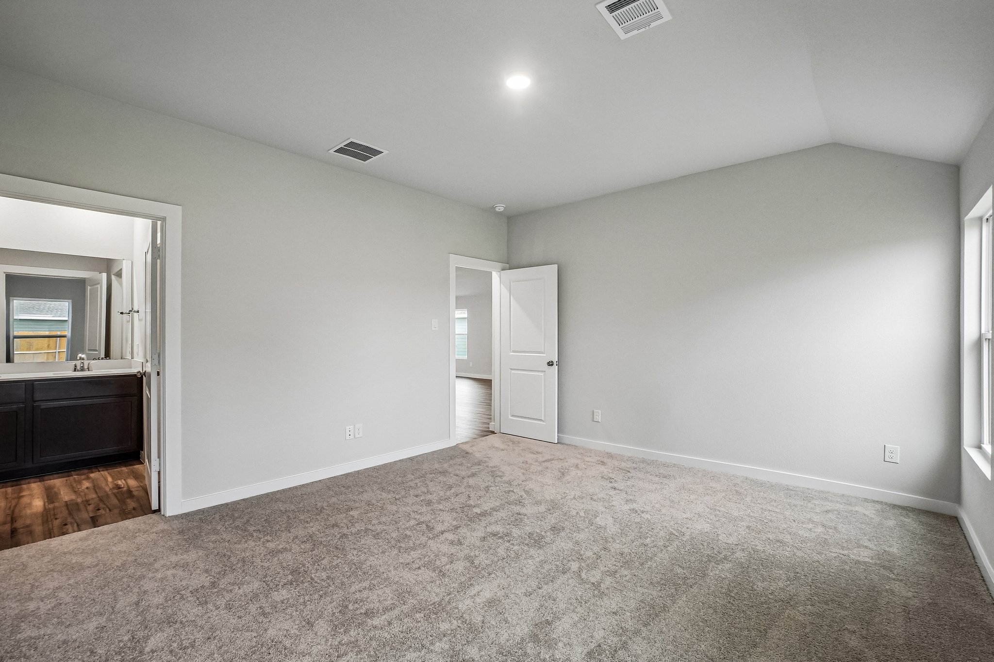 A room with a carpet and a door.