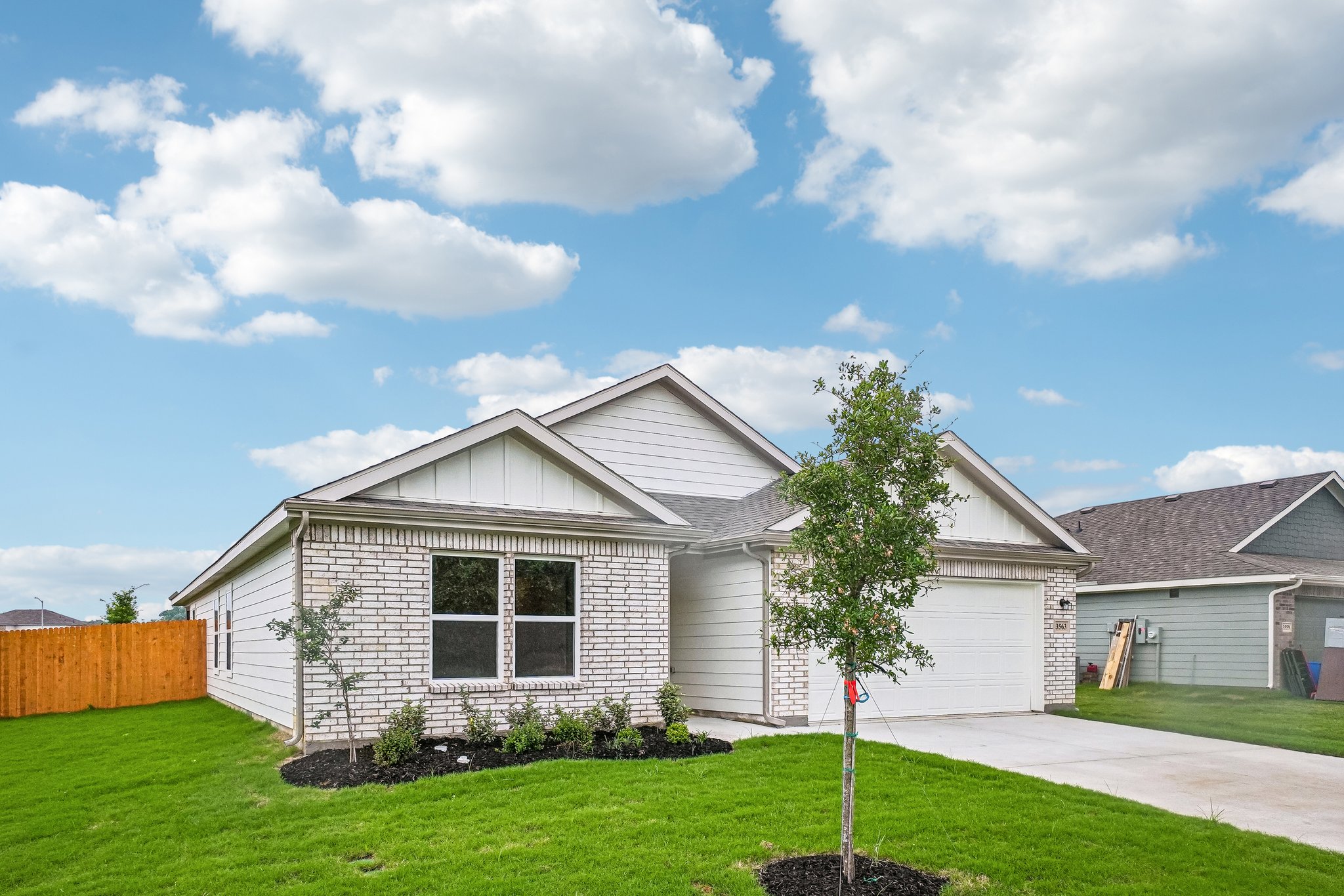 A house with a tree in the front yard.