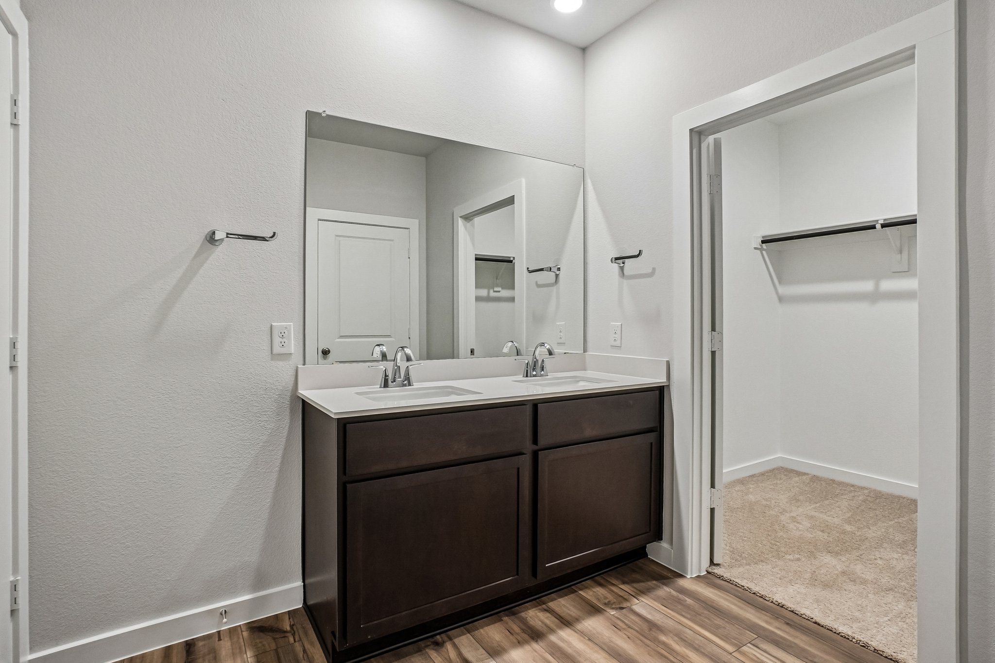 A bathroom with a sink and a shower unit.