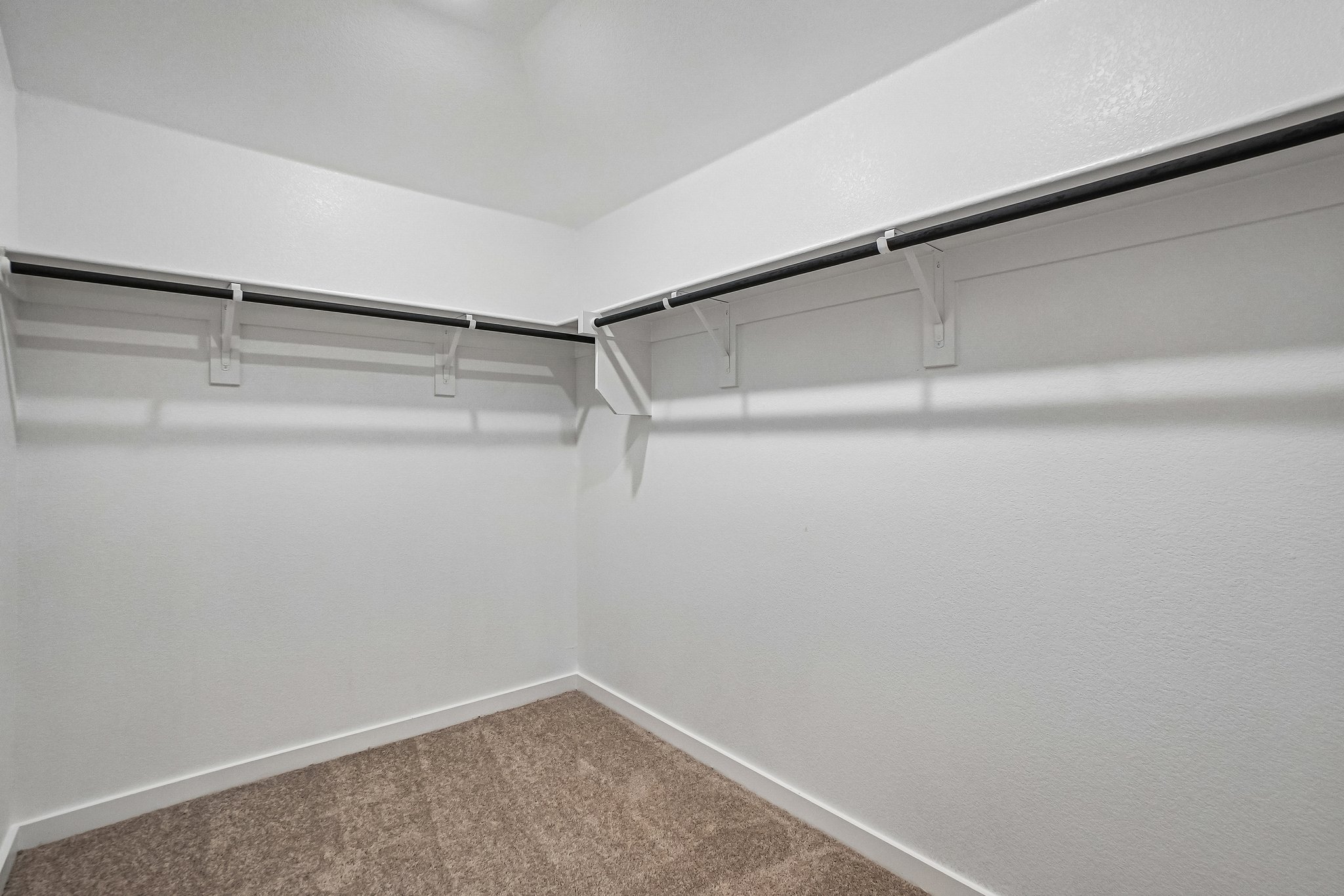 A white wall with a metal railing.