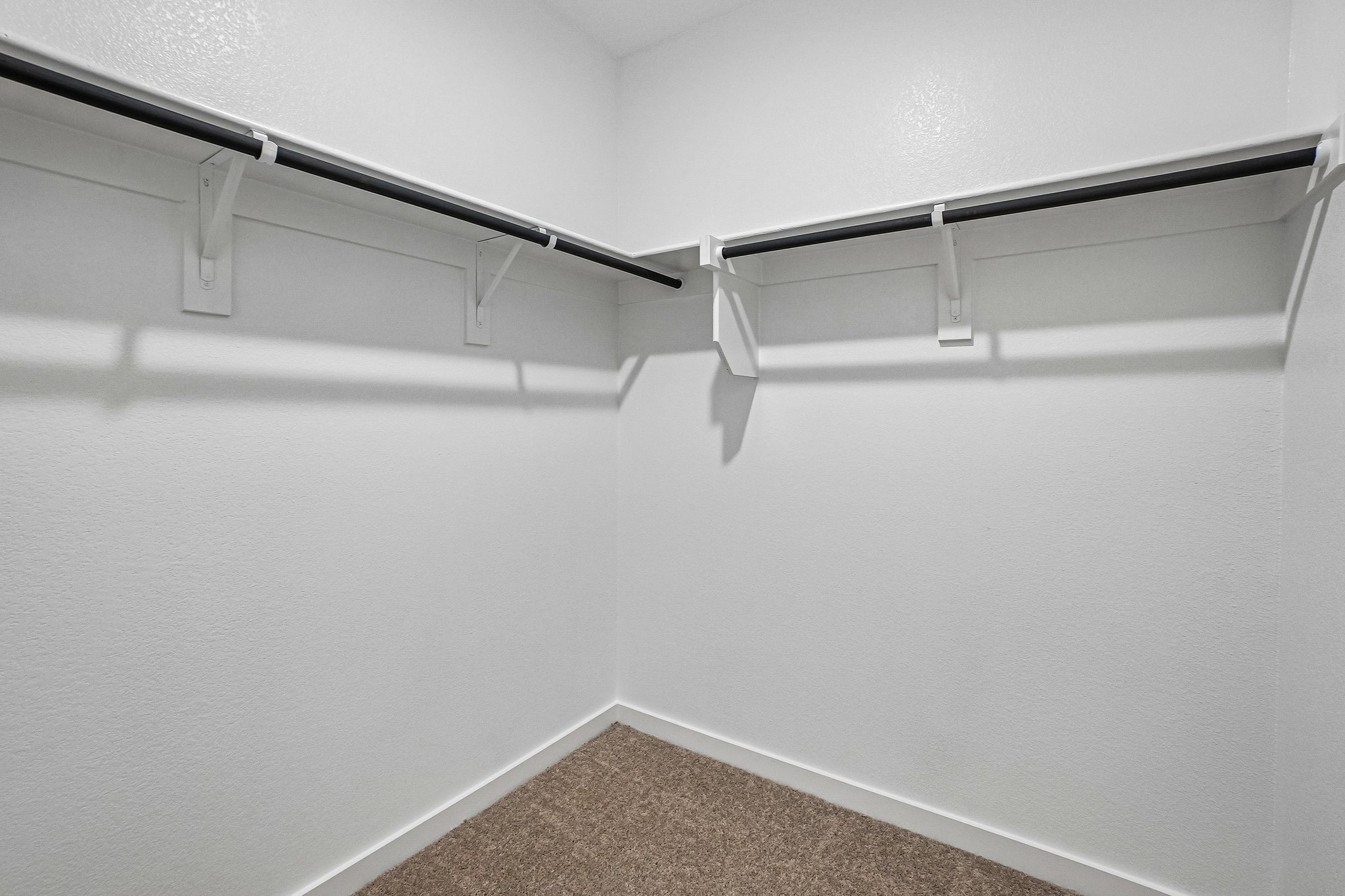 A white wall with a metal railing.