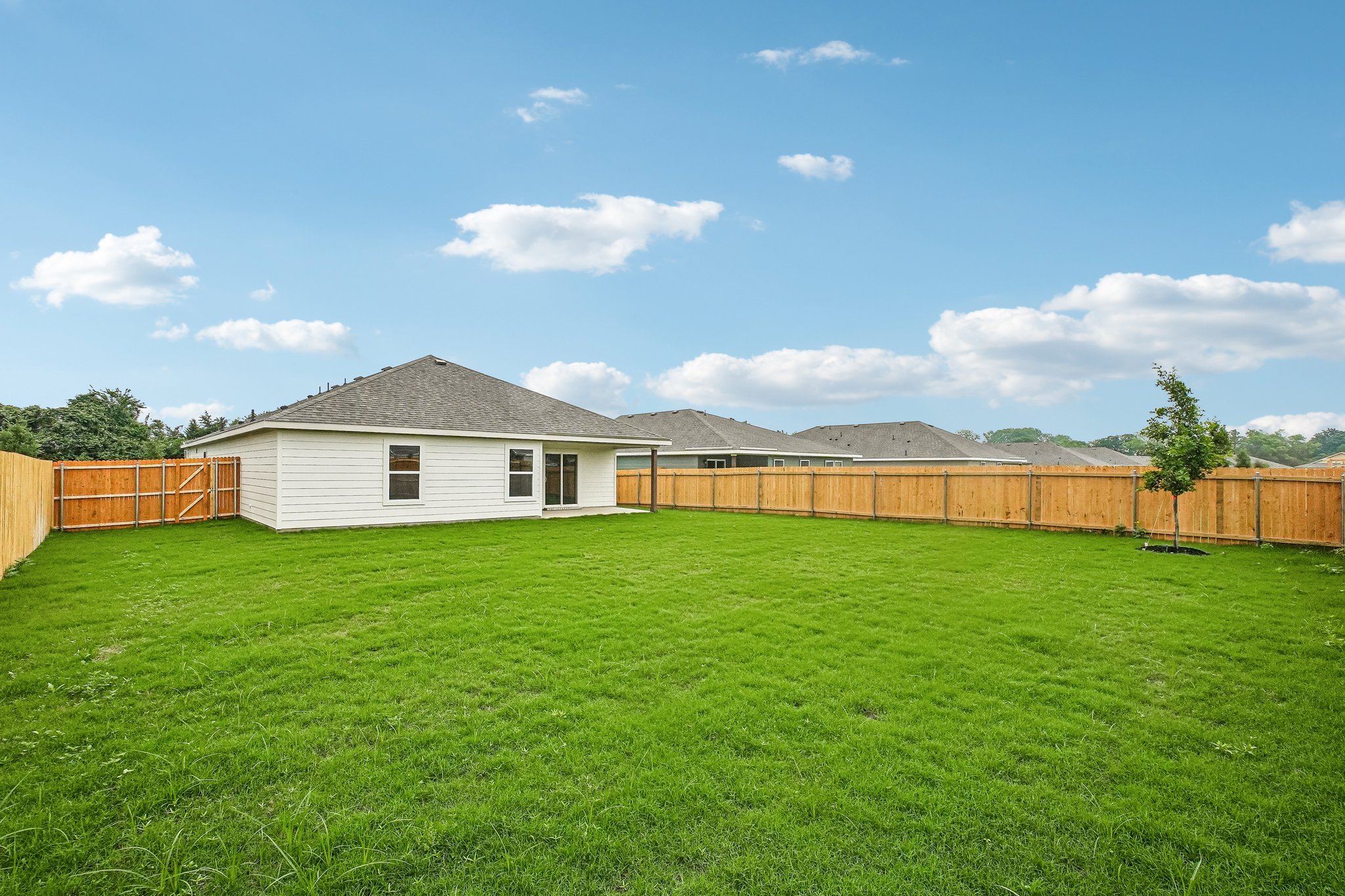 A house in a grassy field.