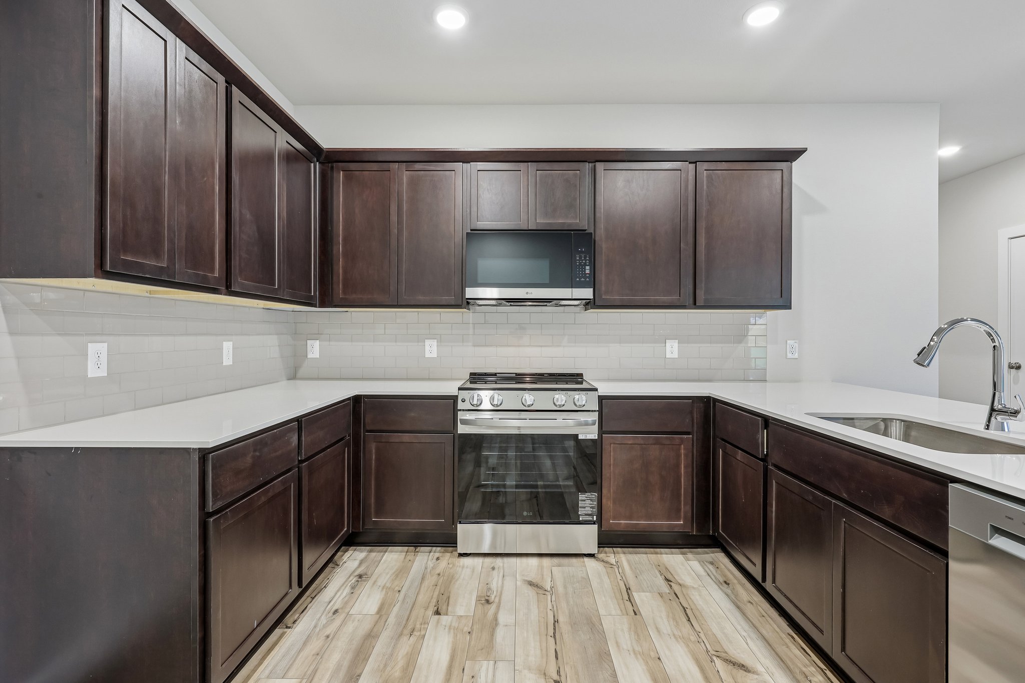 A kitchen with wooden cabinets.
