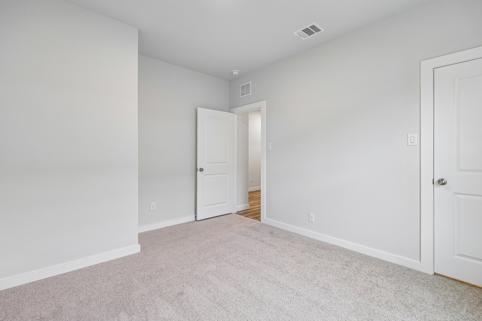 A hallway with white doors.