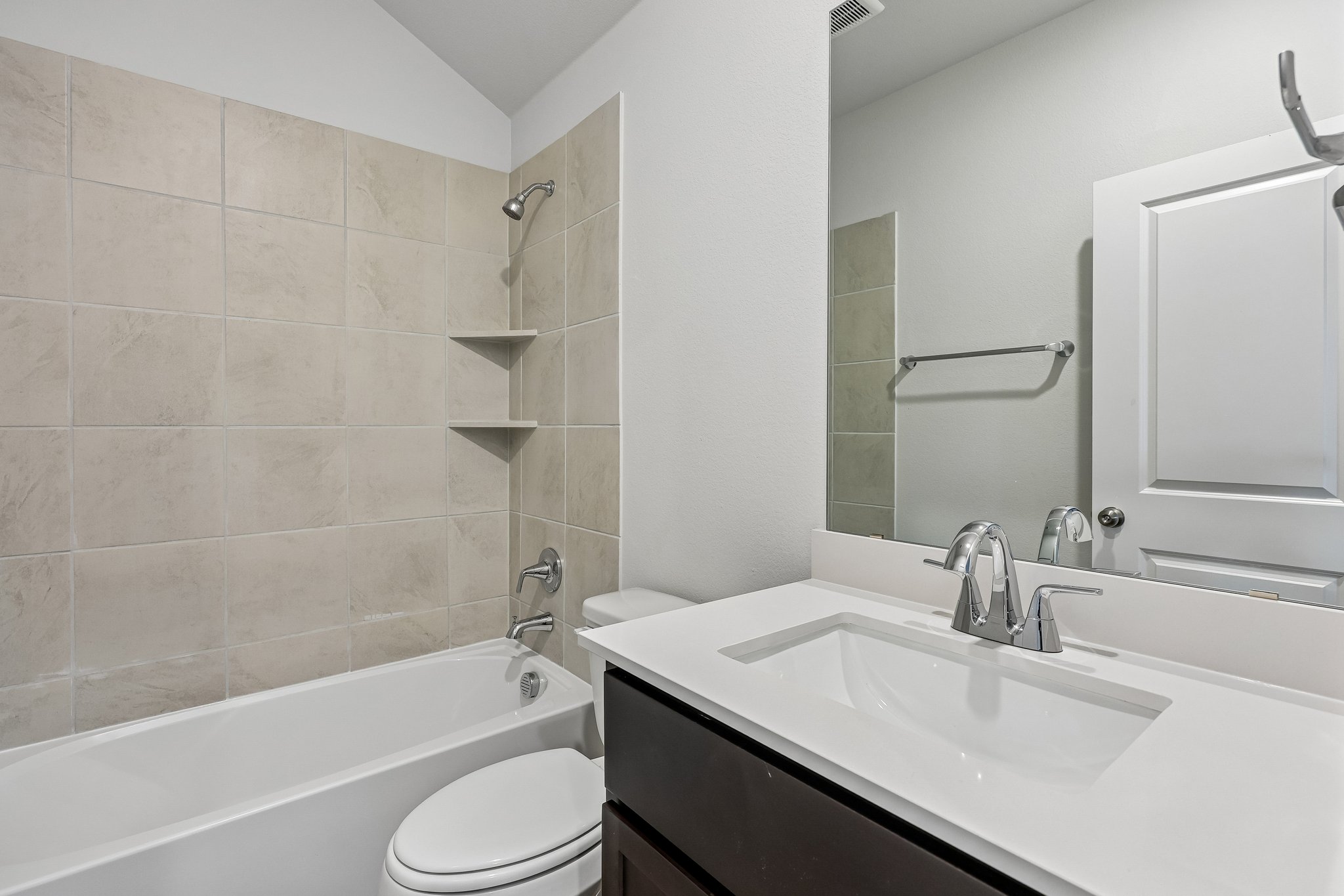 A bathroom with a tub sink and toilet.