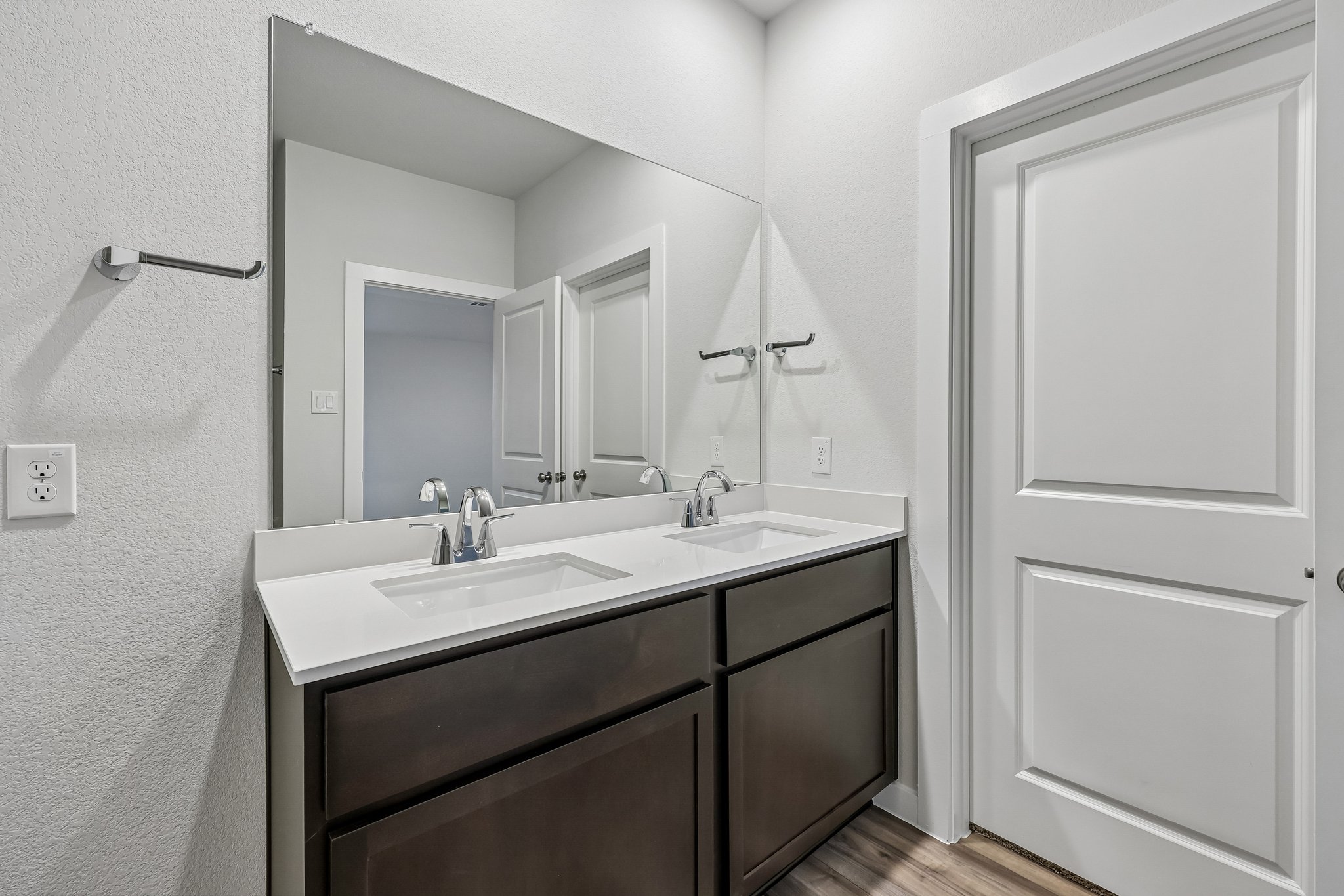 A bathroom with a large mirror.