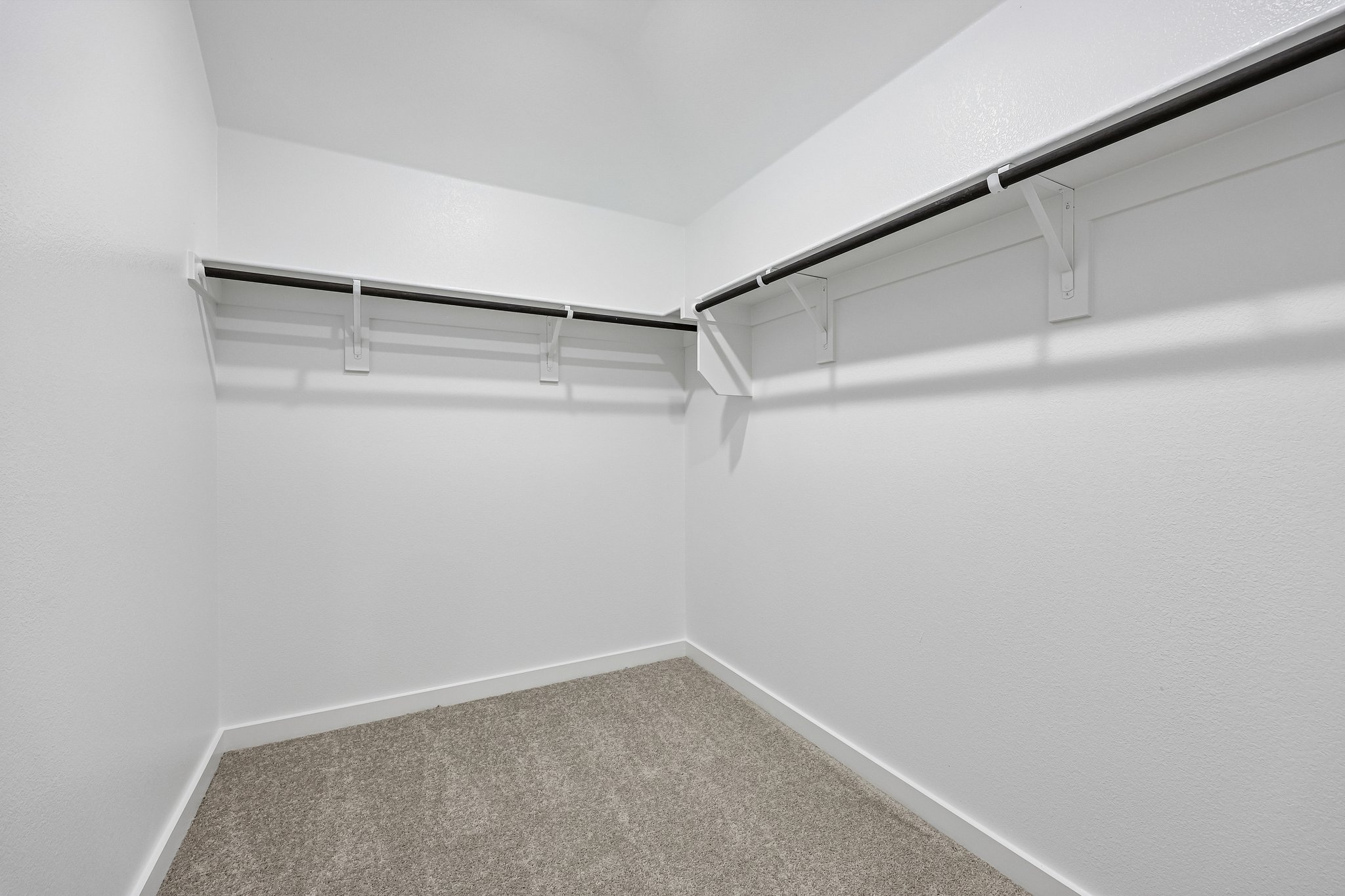 A white wall with a metal railing.