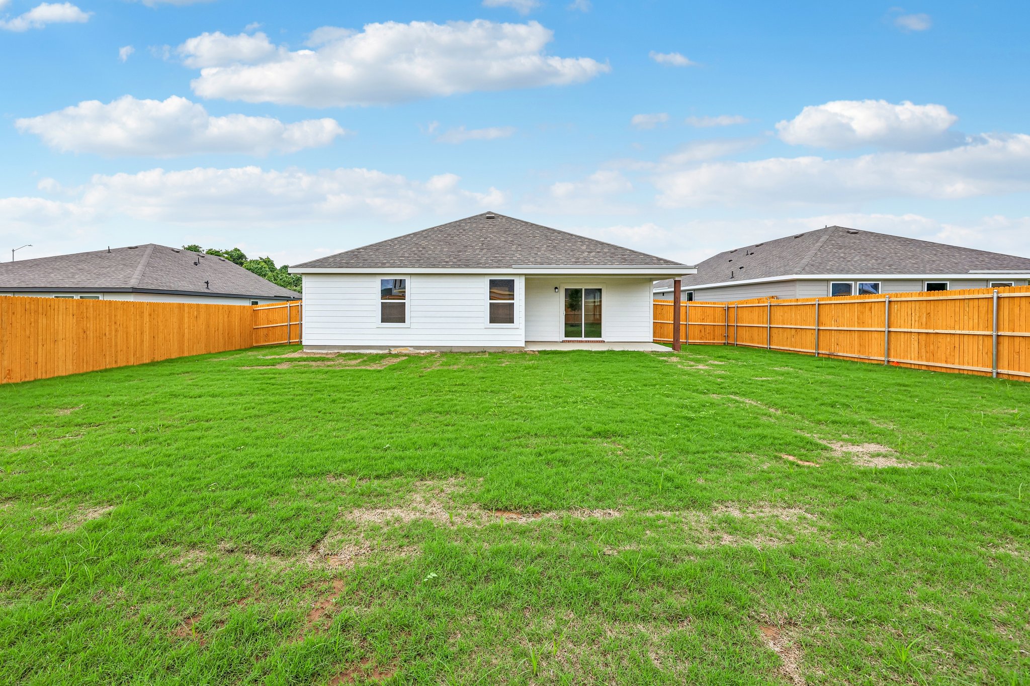 A group of buildings with grass in front of them.