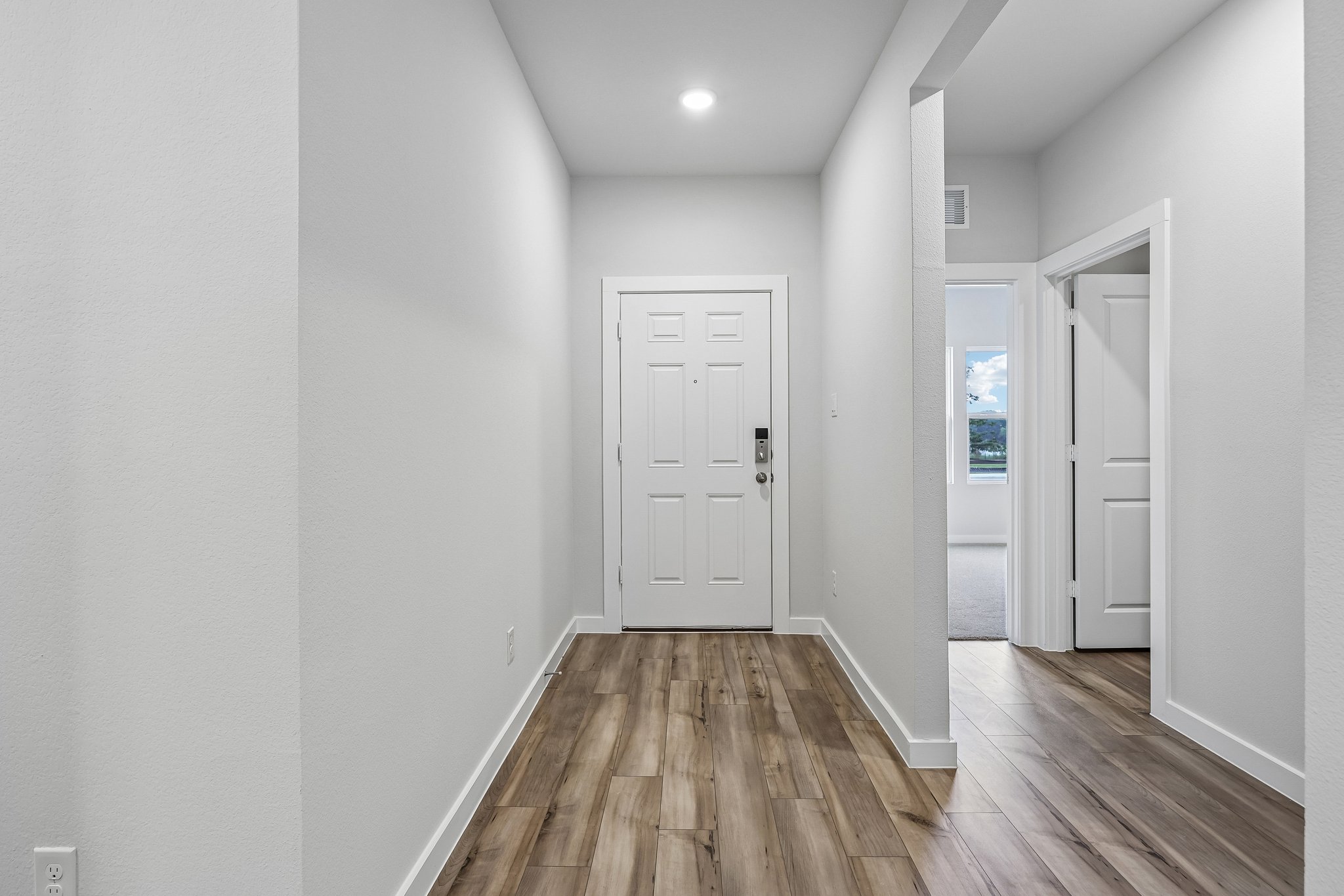 A hallway with white doors.