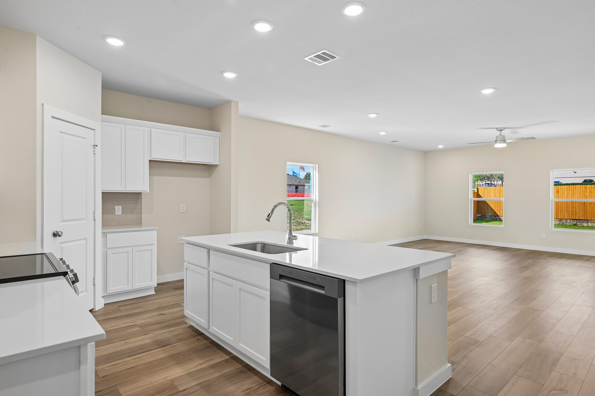 A kitchen with white cabinets.