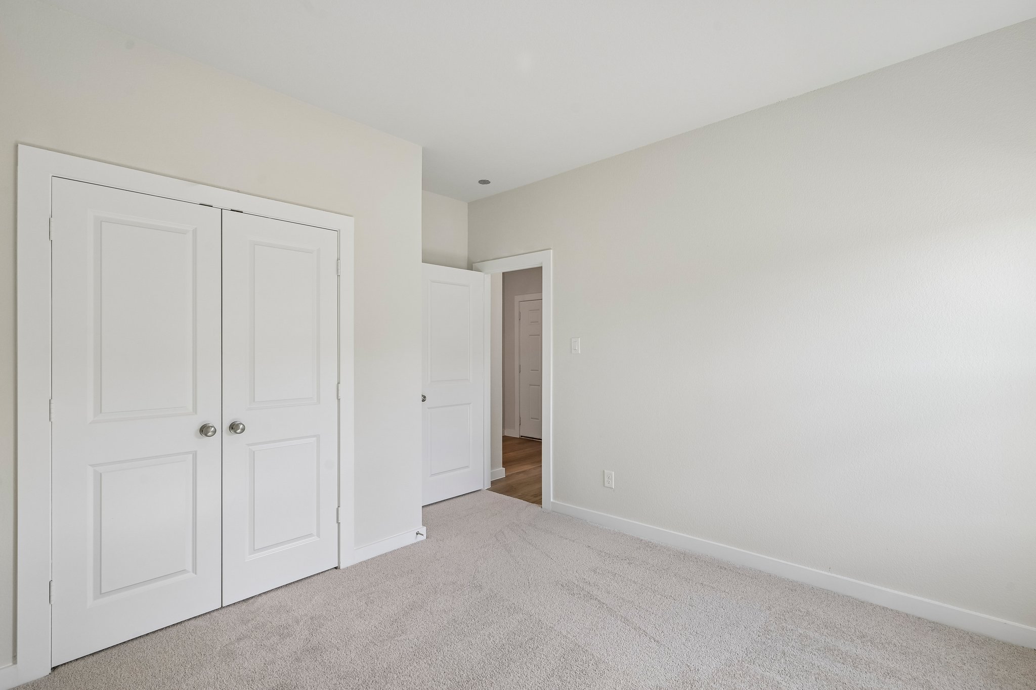 A hallway with white doors.