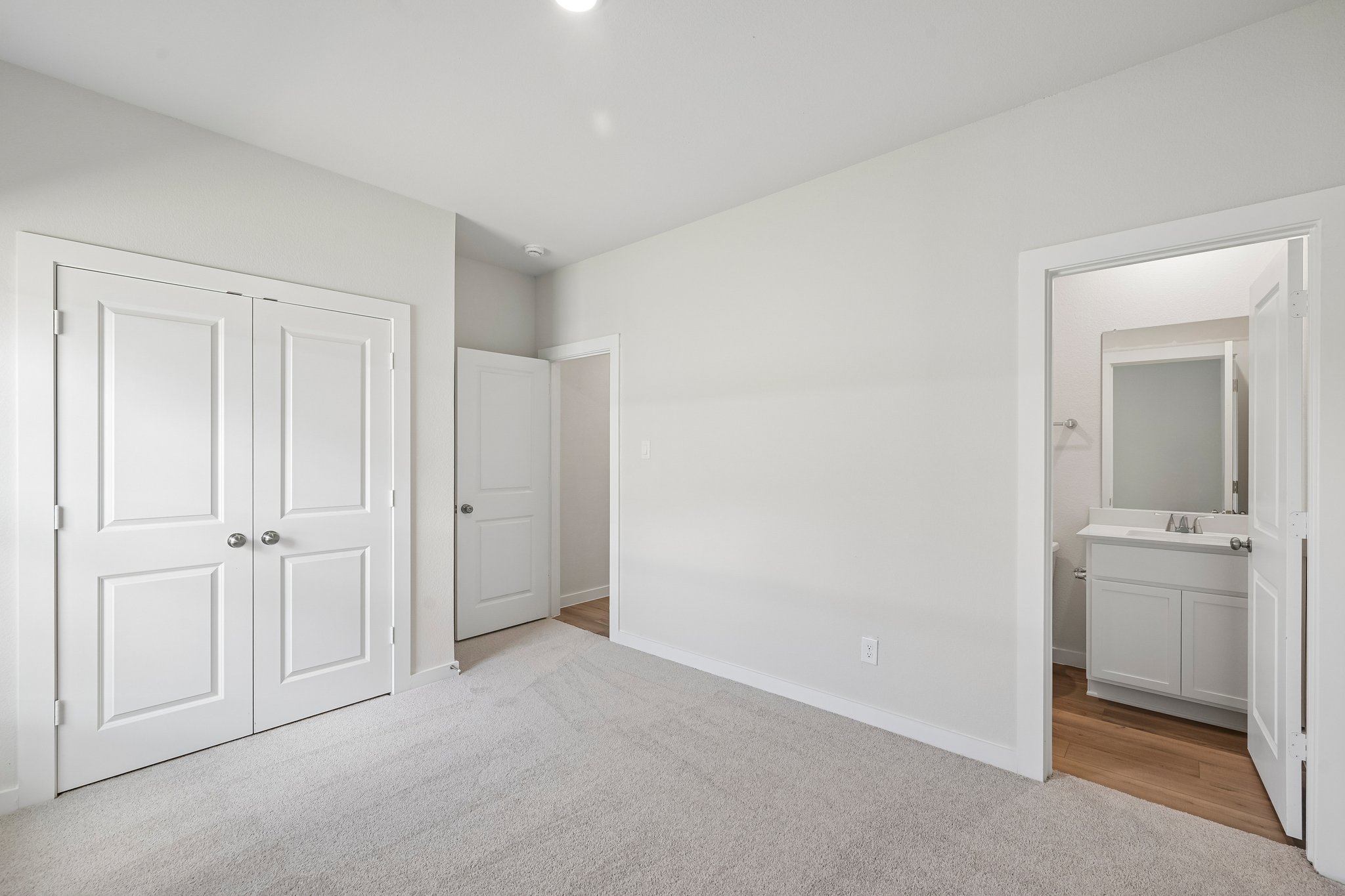 A bathroom with white doors.
