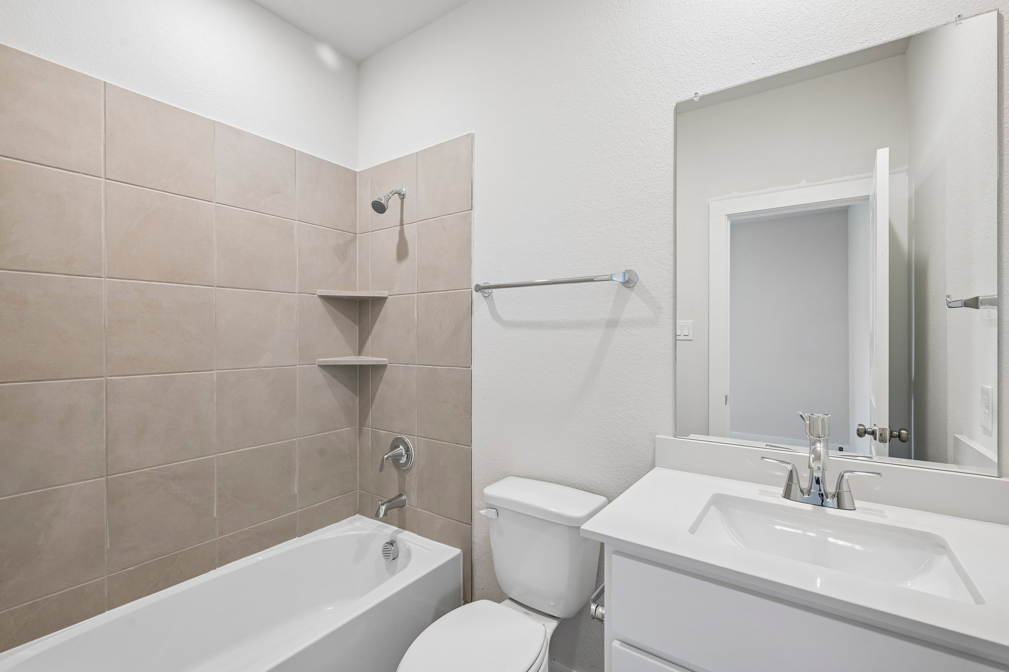 A bathroom with a tub sink and toilet.