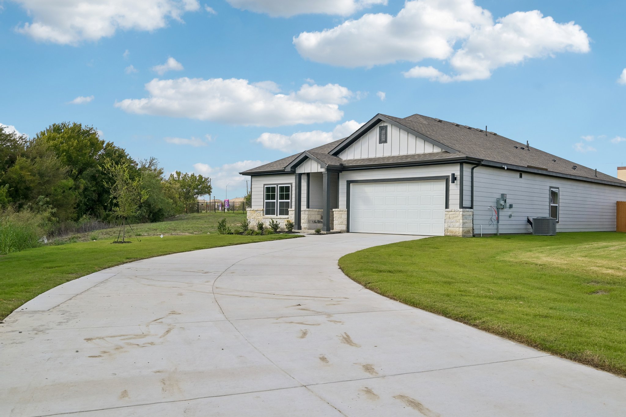 A driveway leading to a house.
