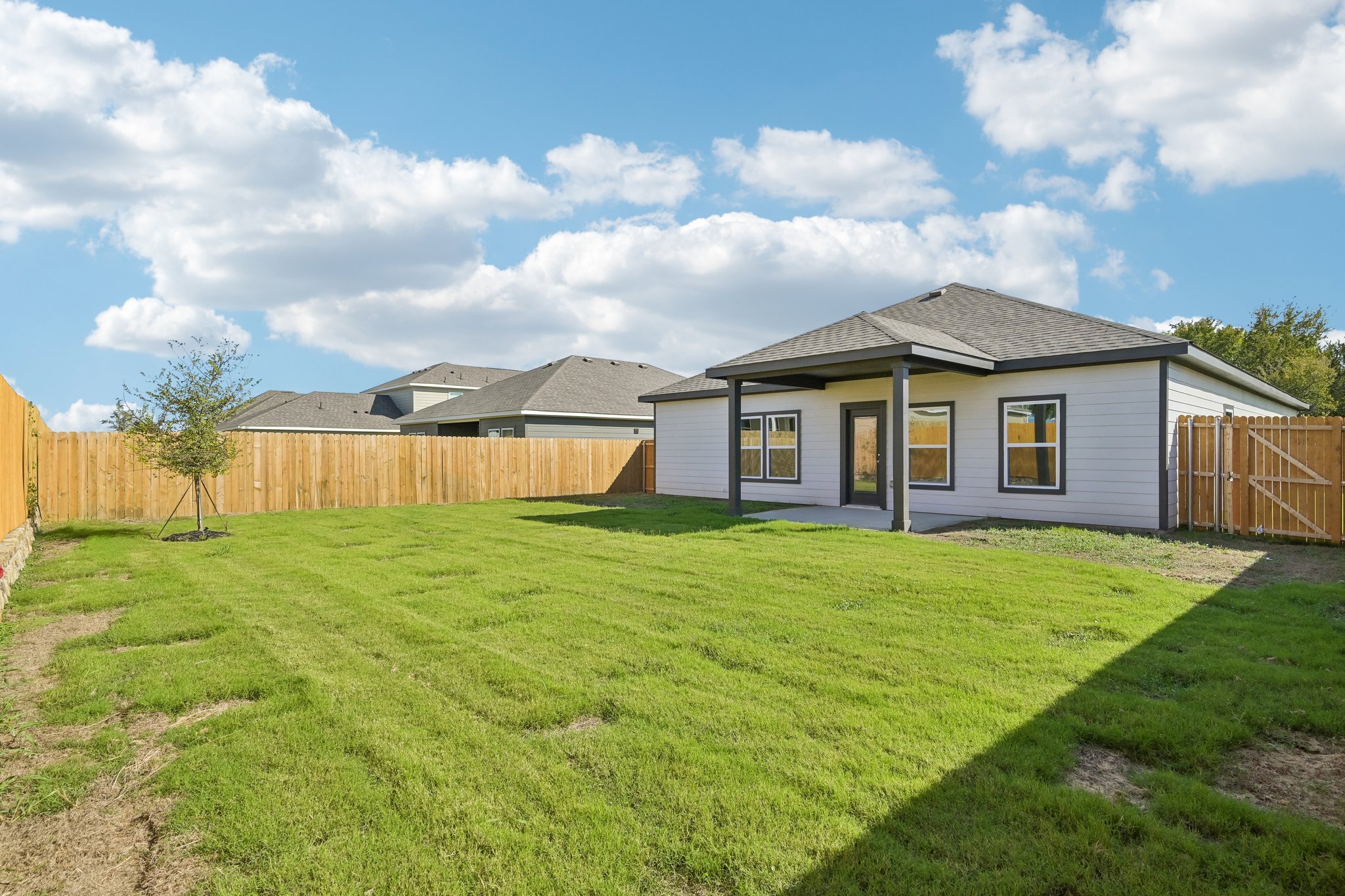 A house with a fence and grass.