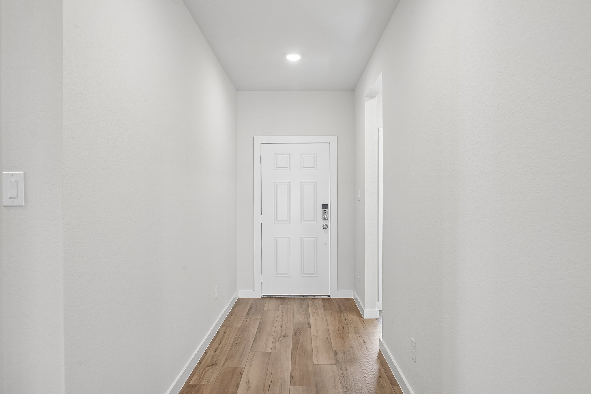A hallway with white walls.