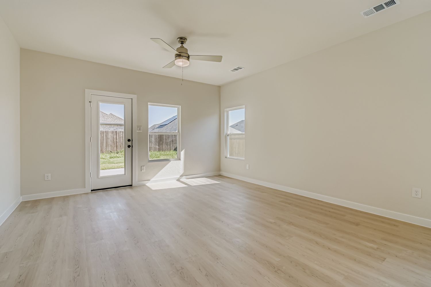 A room with a wood floor and a ceiling fan.