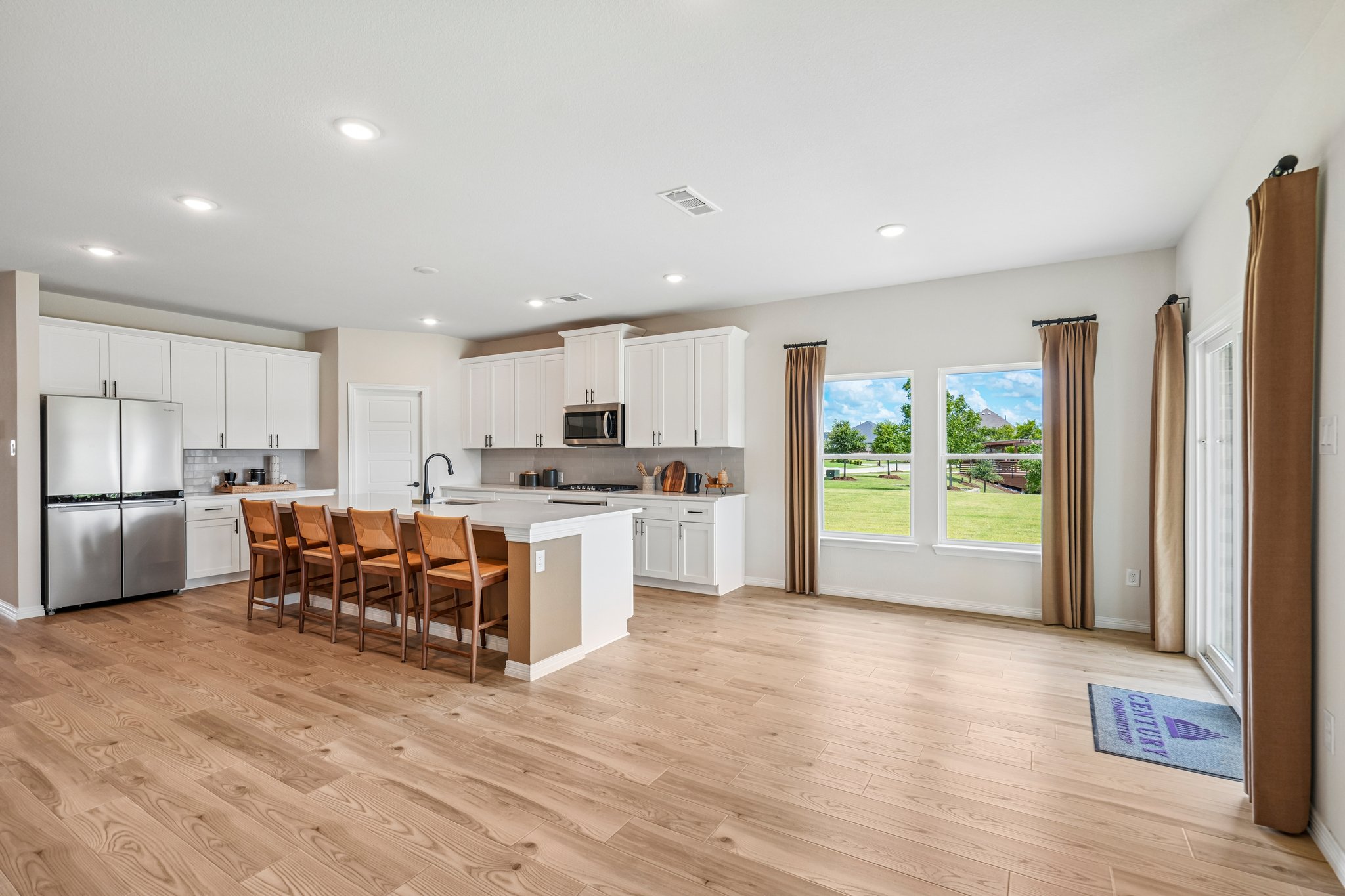 A kitchen with a wood floor.