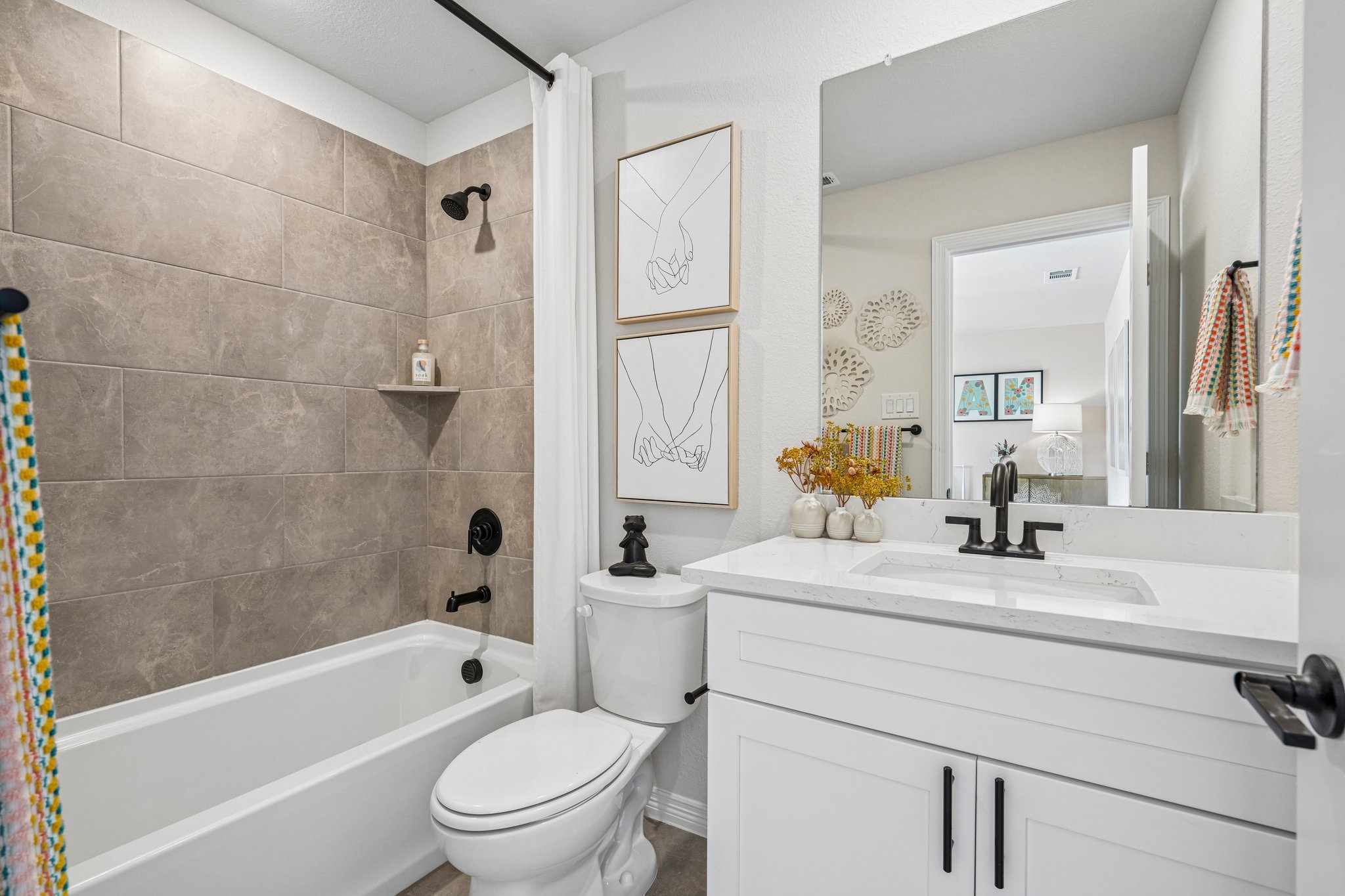 A bathroom with a tub sink and toilet.