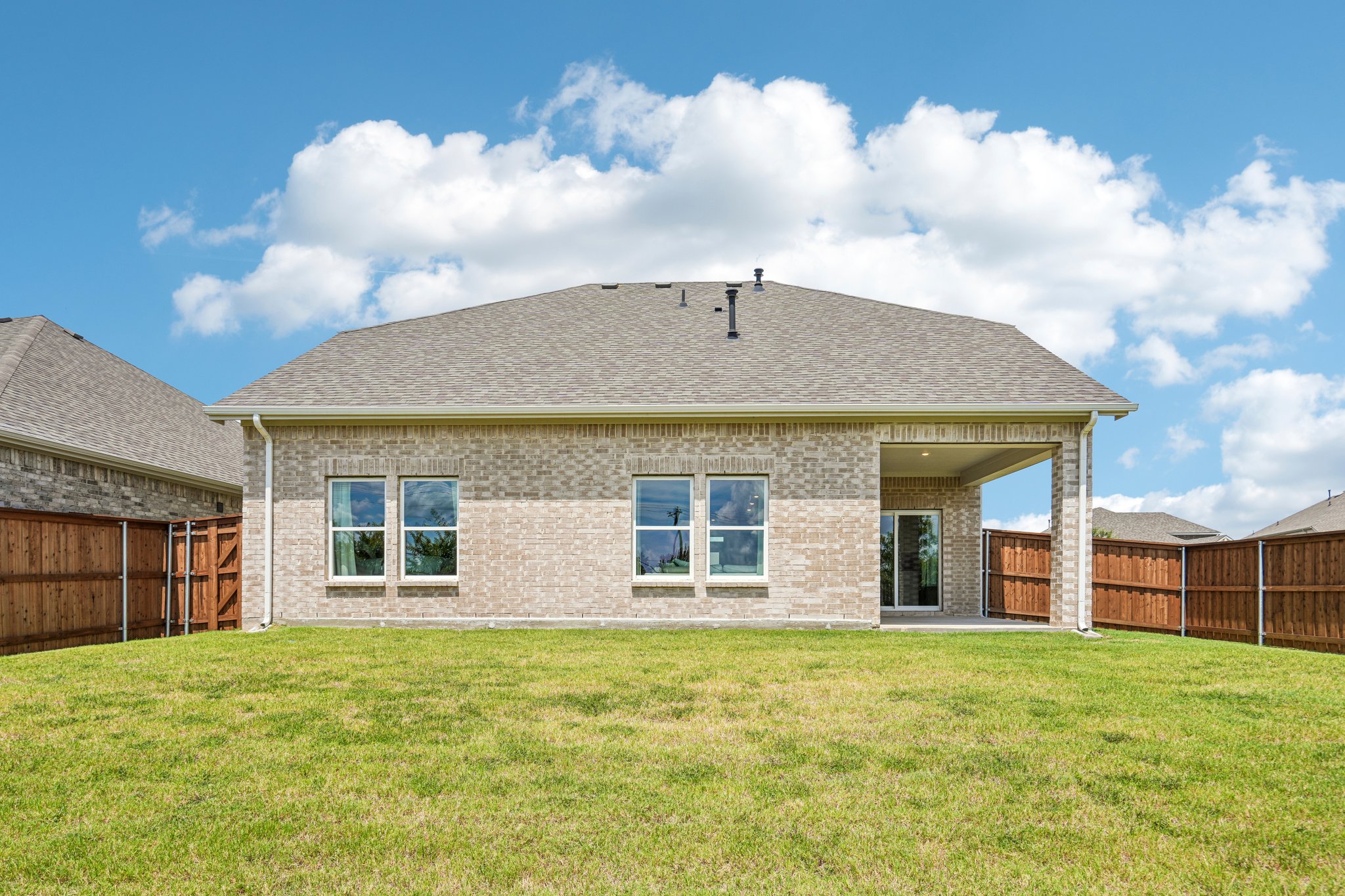A house with a grass yard.