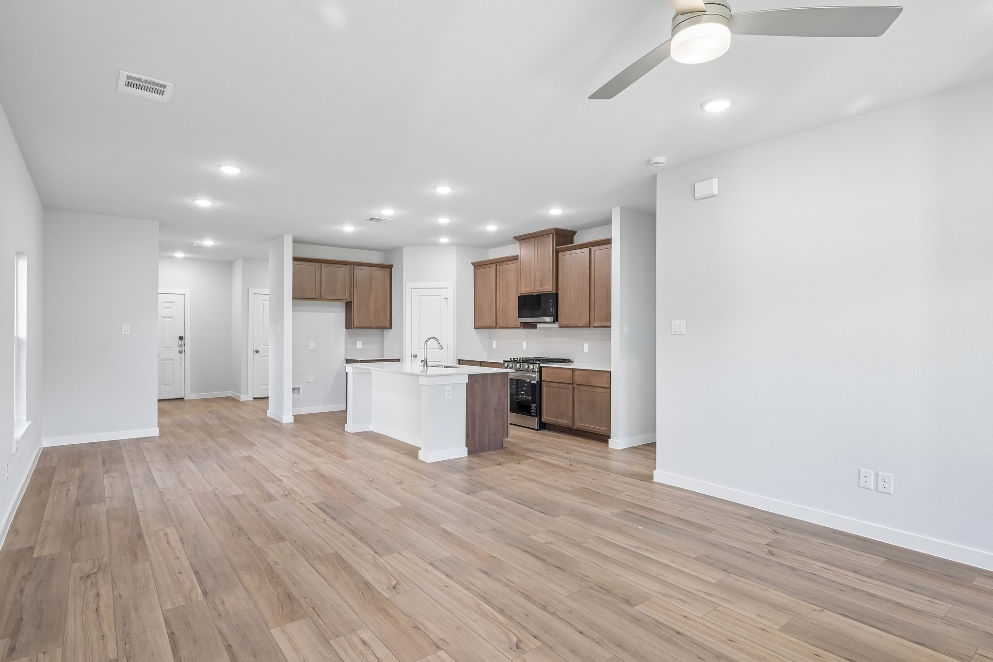 A large kitchen with wooden floors.