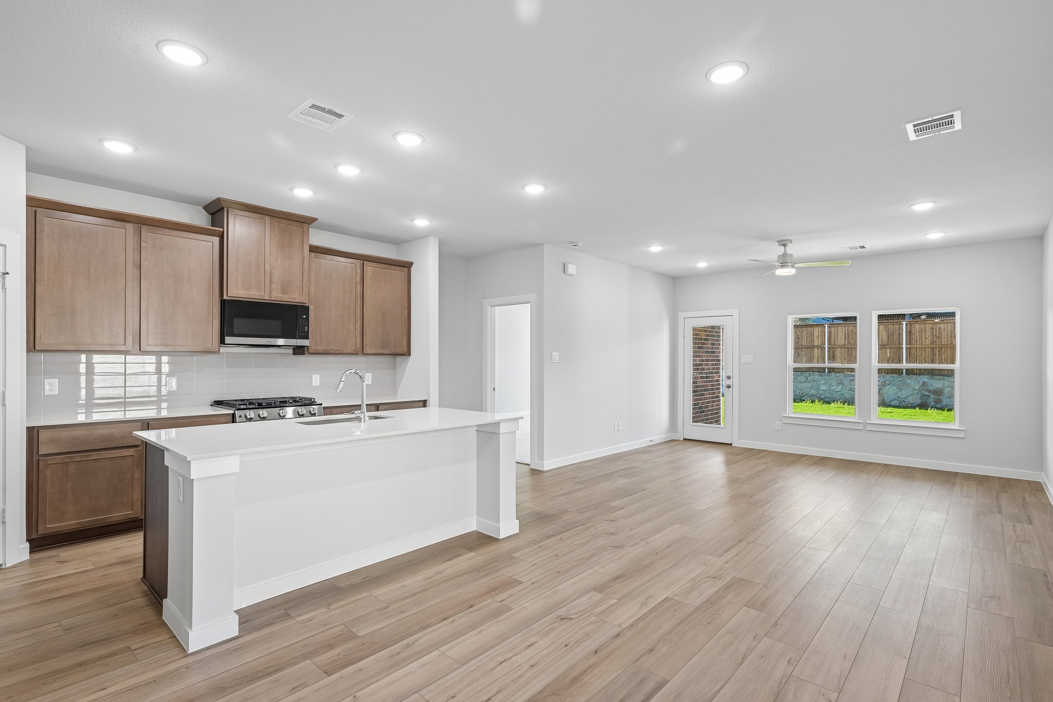 A large kitchen with wooden floors.