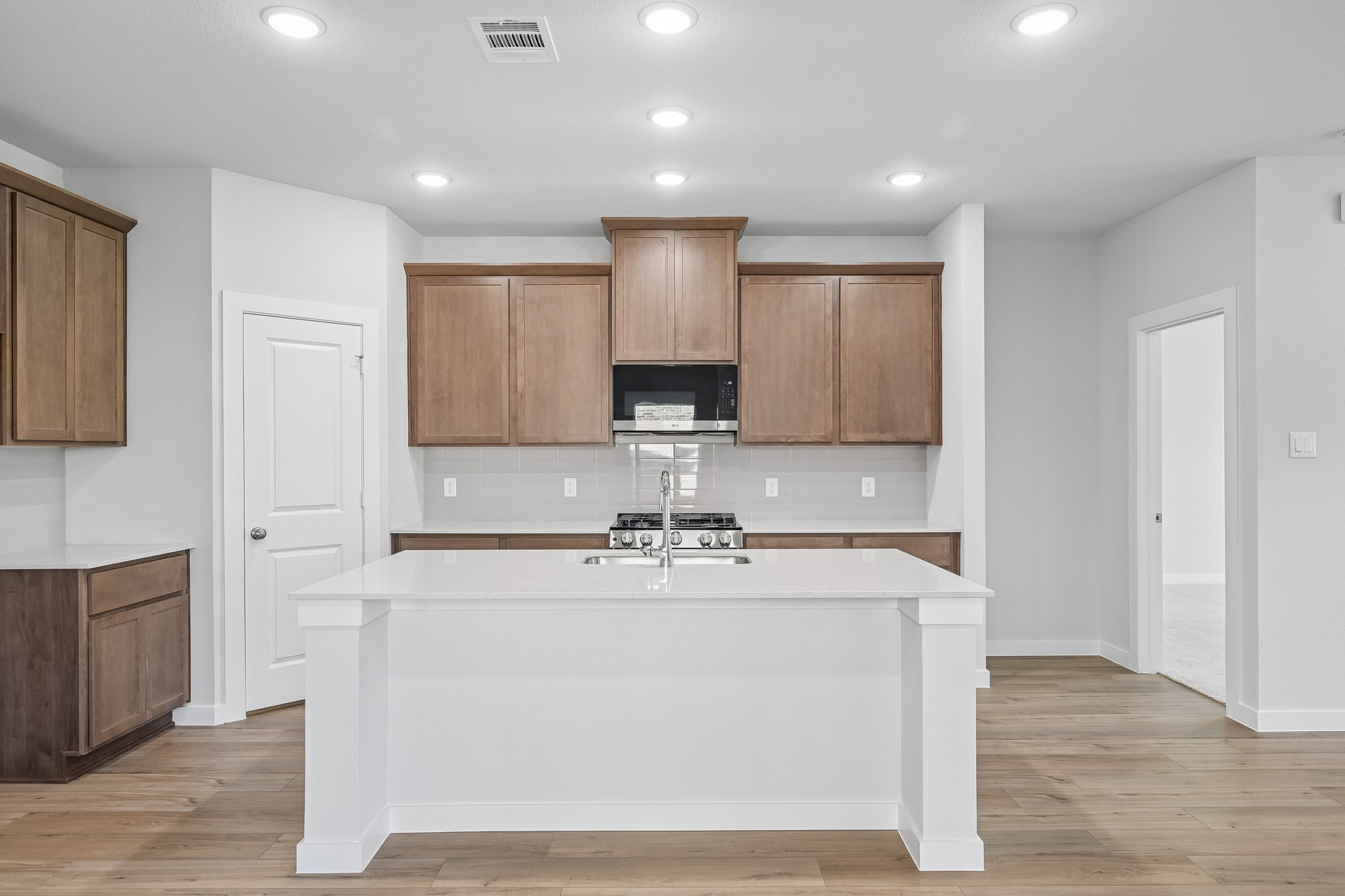 A kitchen with wooden cabinets.