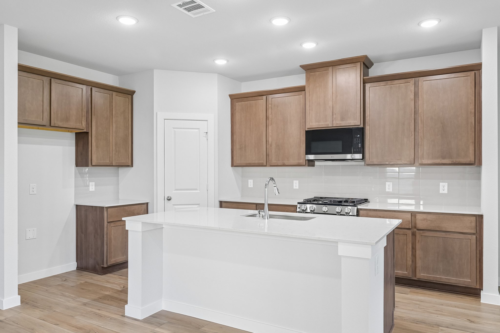 A kitchen with wooden cabinets.