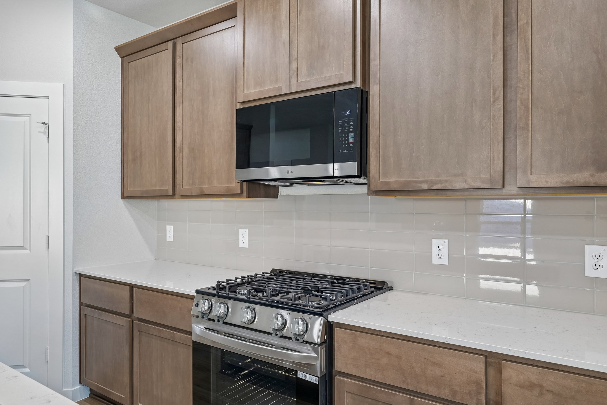 A kitchen with wooden cabinets.