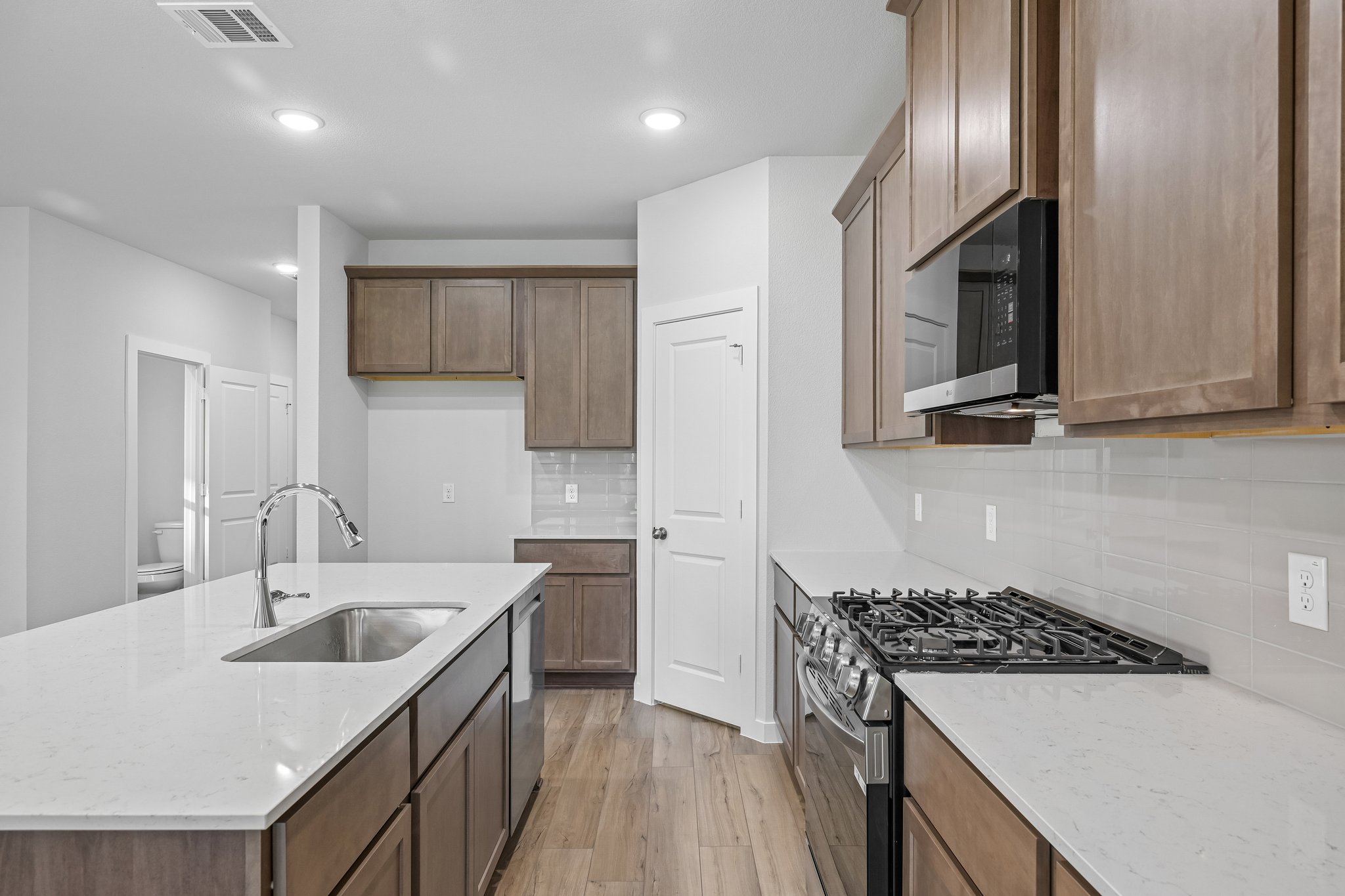 A kitchen with wooden cabinets.