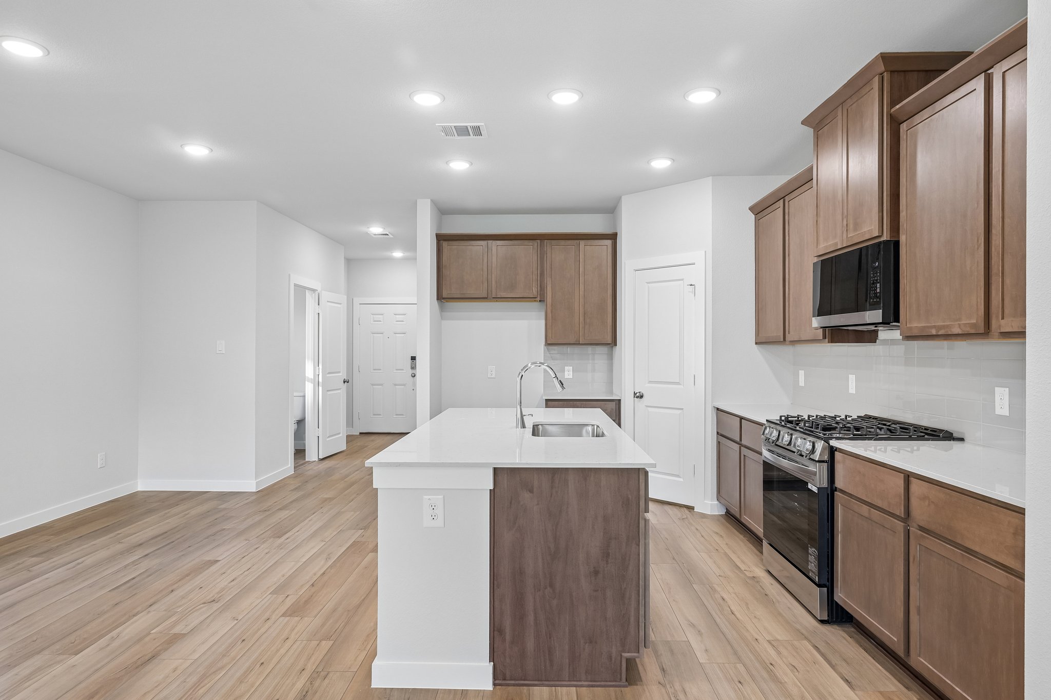 A kitchen with wooden cabinets.