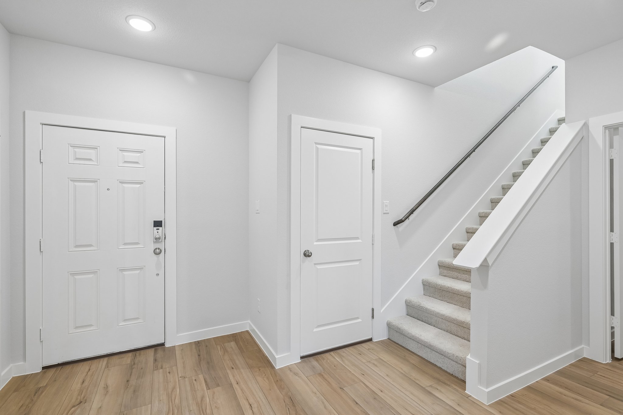 A staircase leading up to a white door.