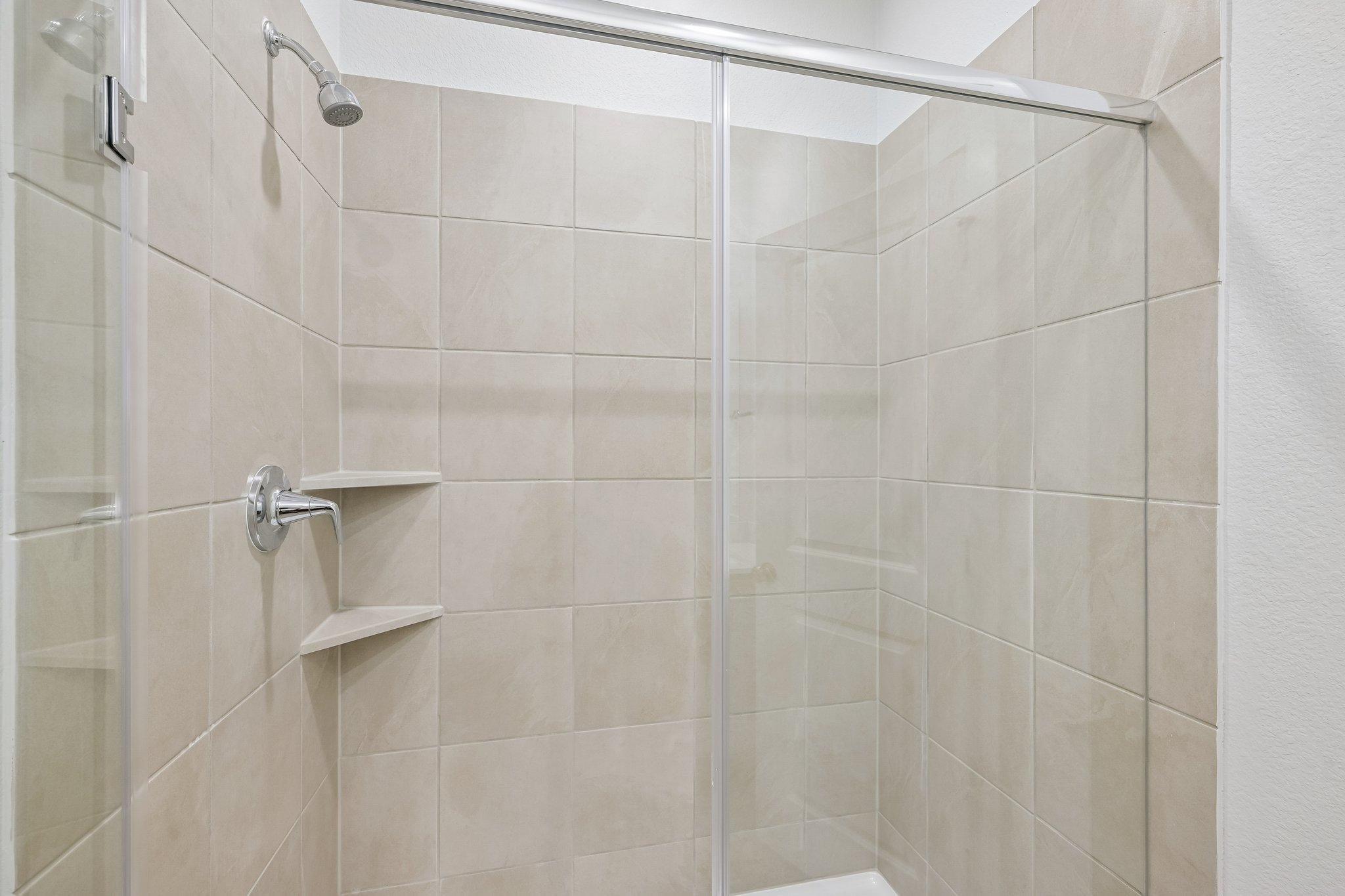 A shower with a glass door.