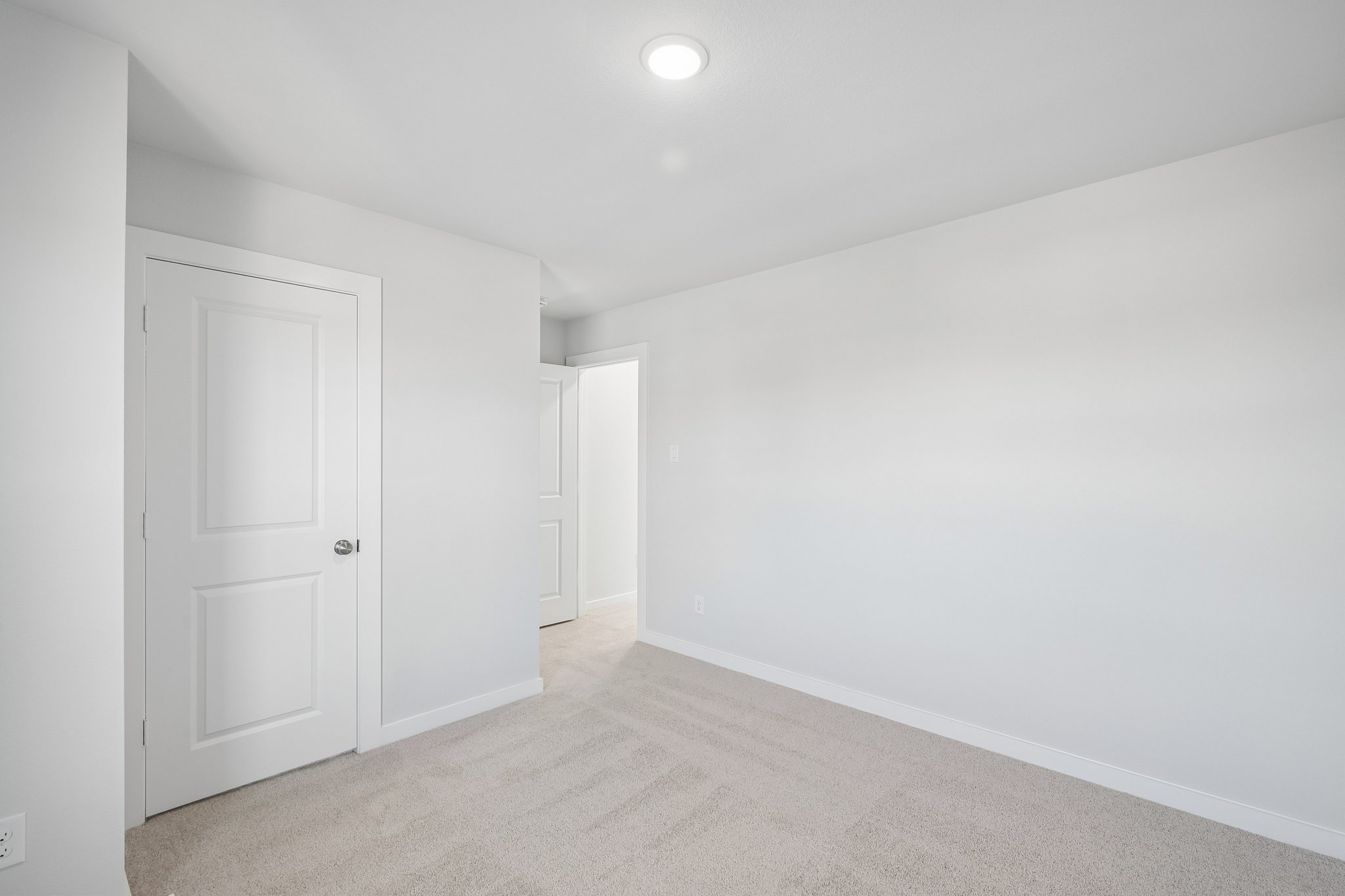 A hallway with white doors.