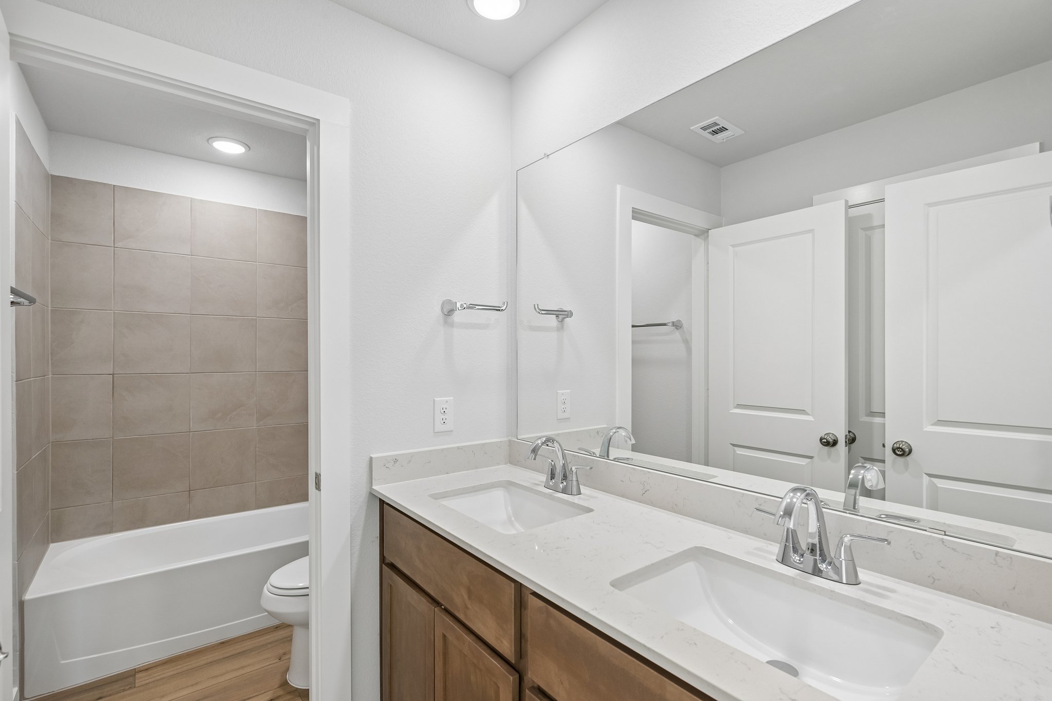 A bathroom with a tub sink and toilet.