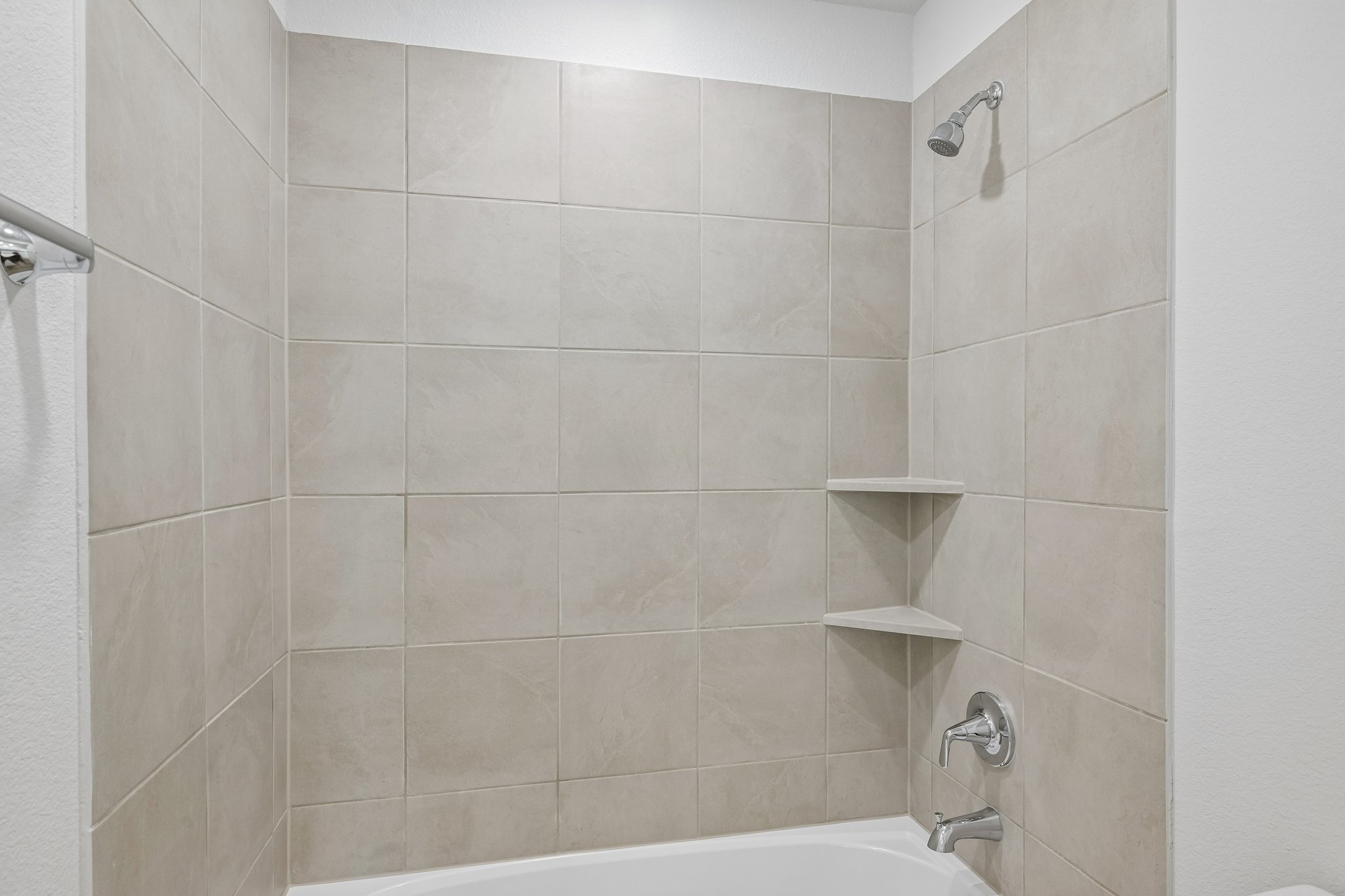 A white tiled bathroom.