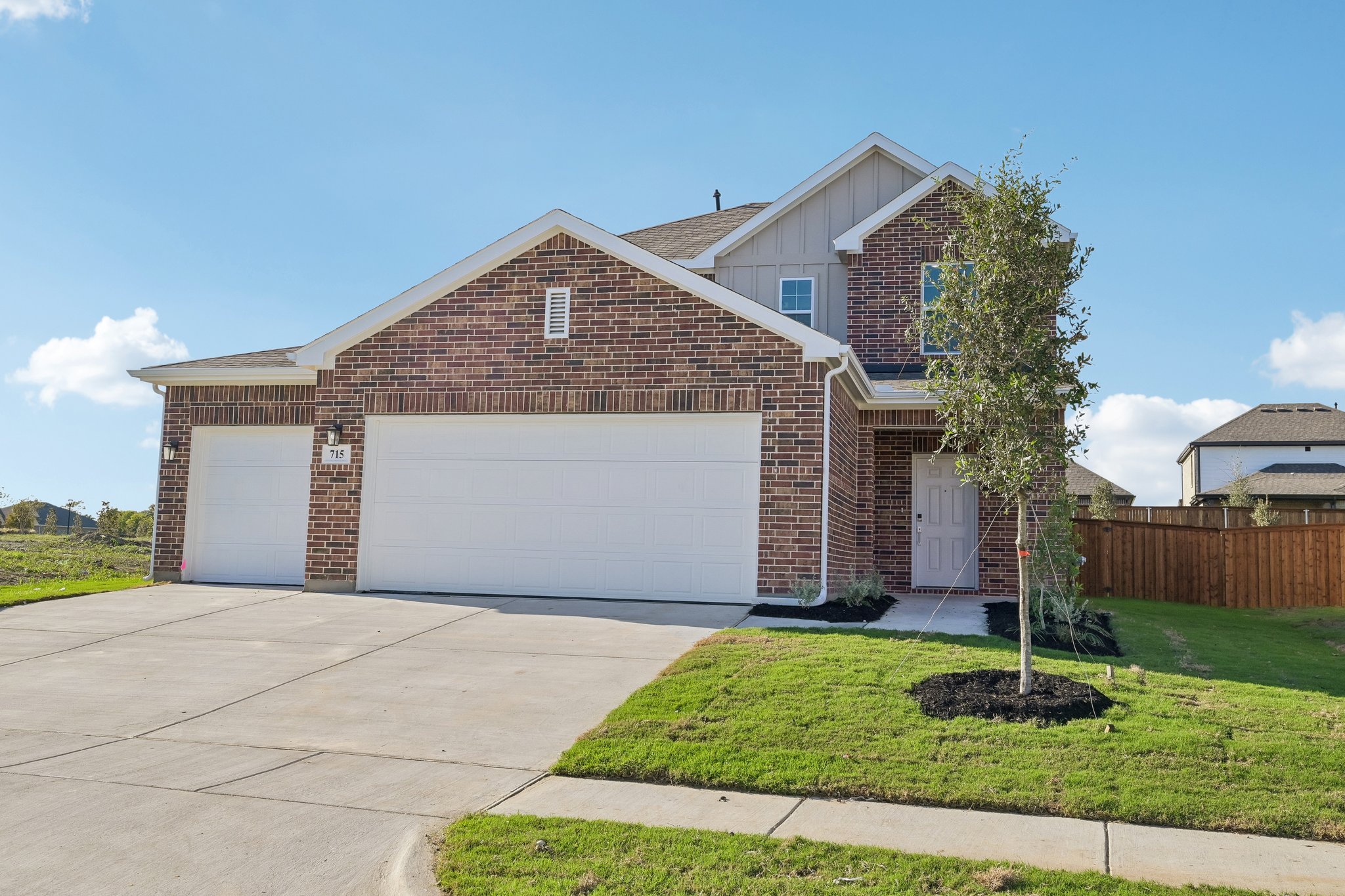 A brick house with garages.