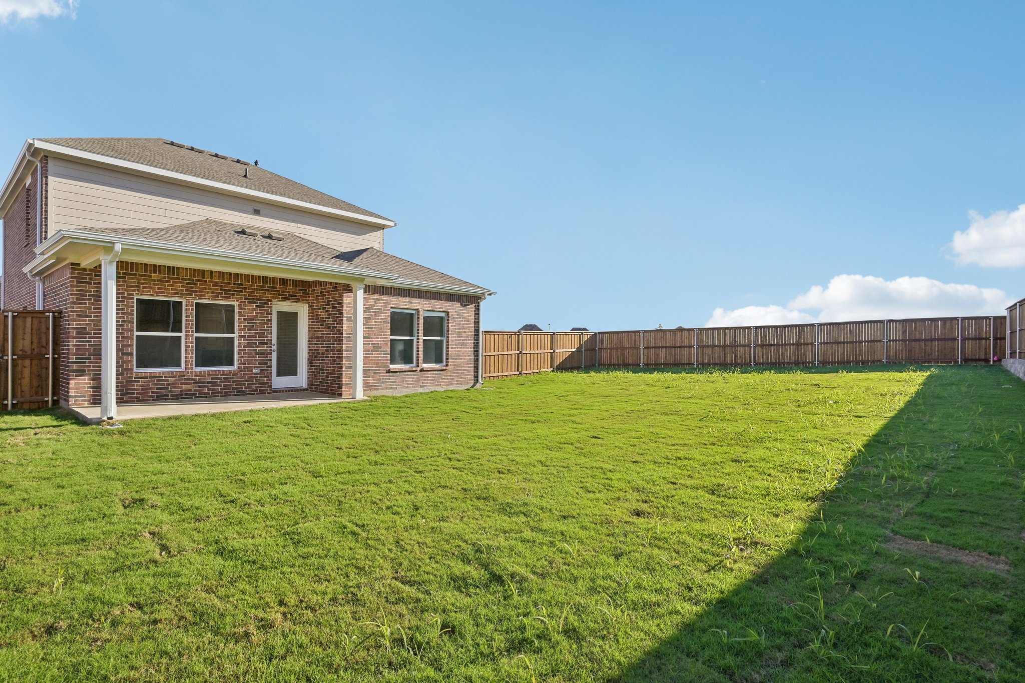 A house with a fence and grass.