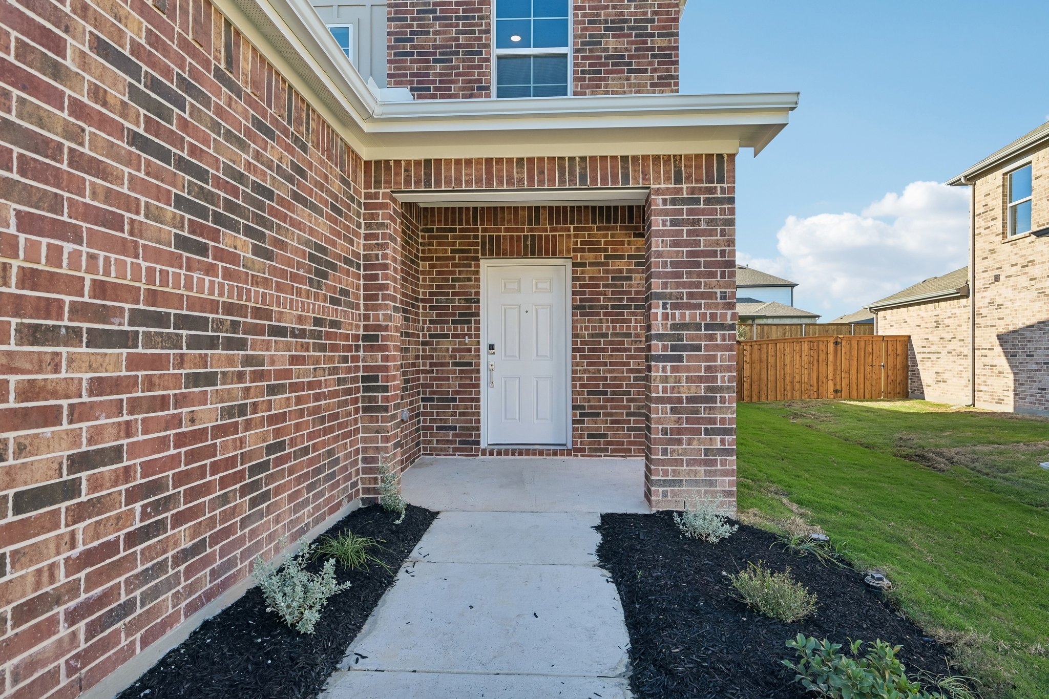 A brick building with a white door.