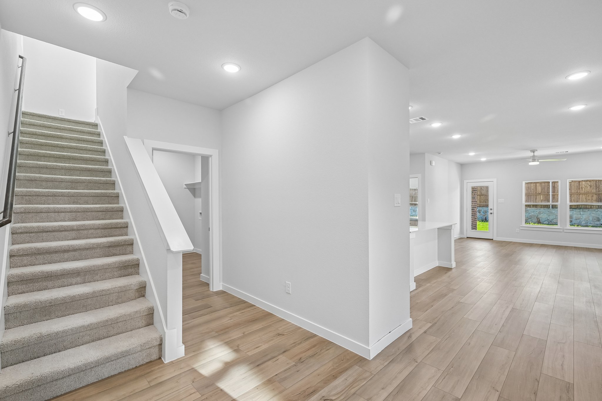 A large white room with a wood floor and white walls.