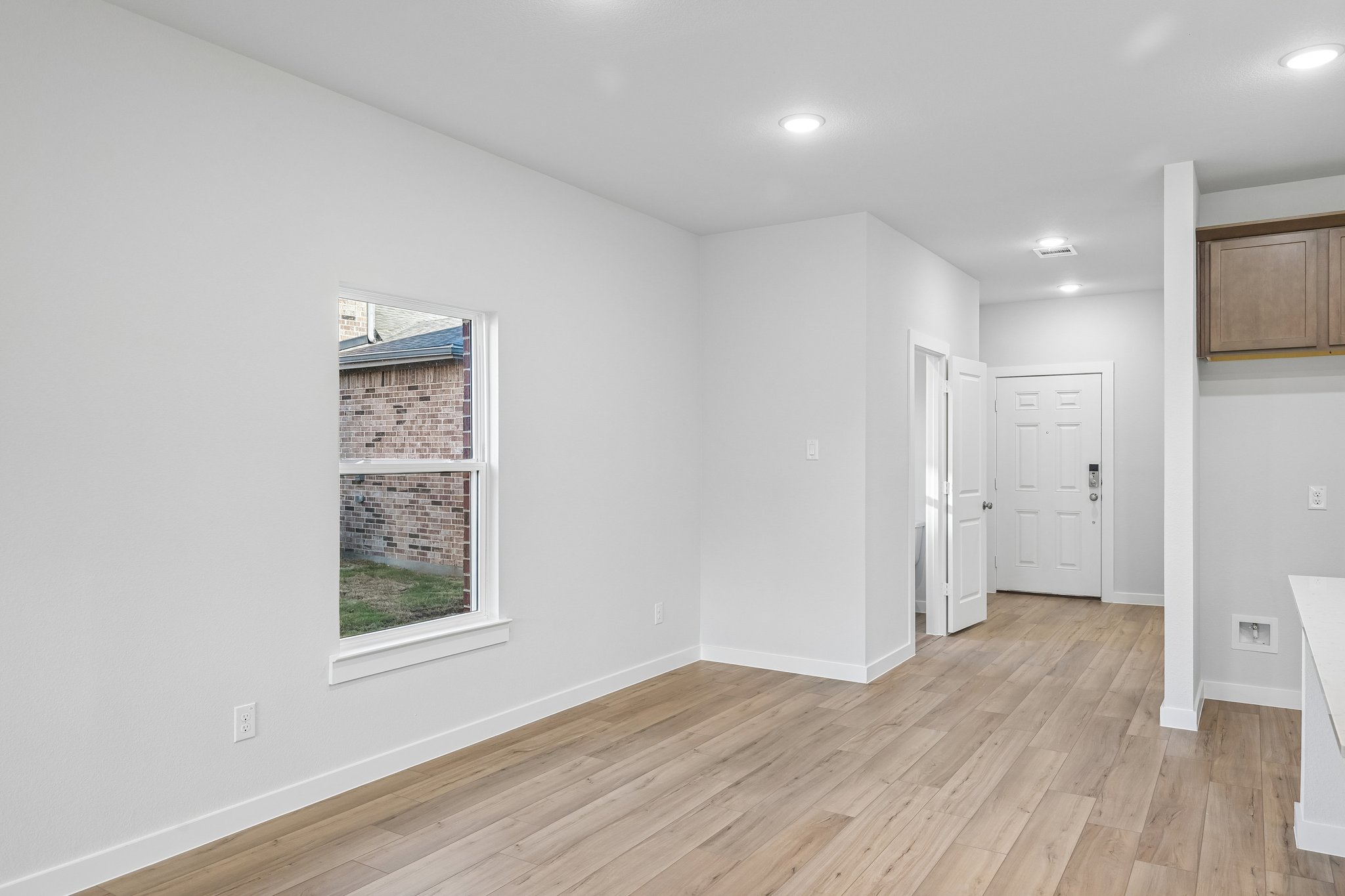 A room with white walls and a wood floor.