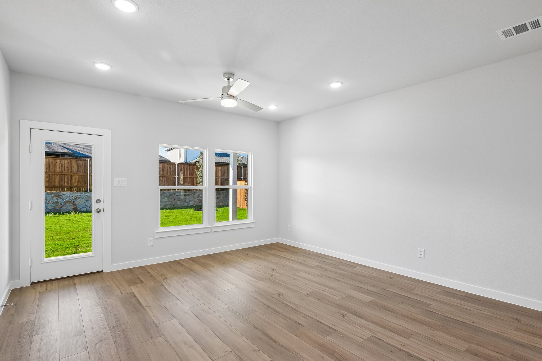 A room with a wood floor and a wood floor with a window and a wood floor with a.