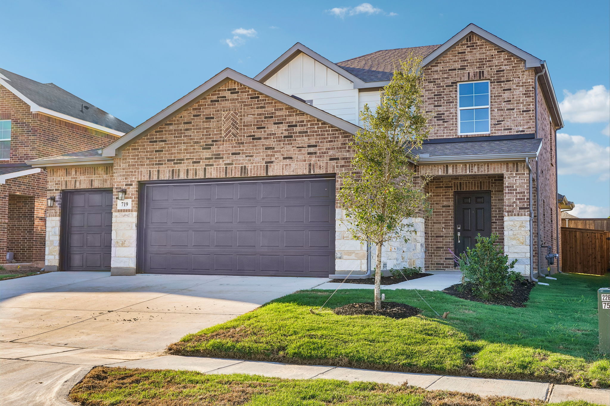 A brick house with a garage.