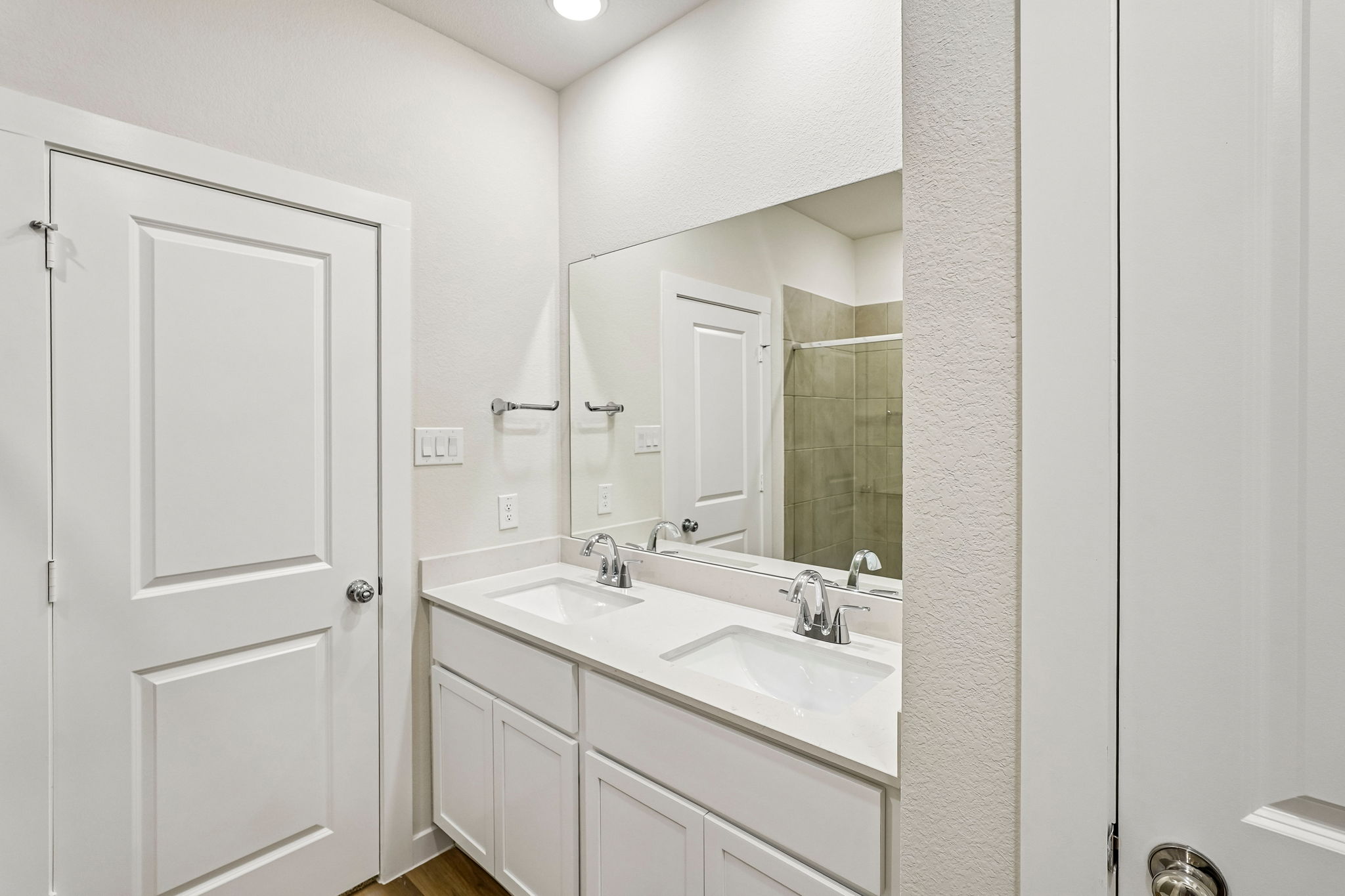 A bathroom with a large mirror.