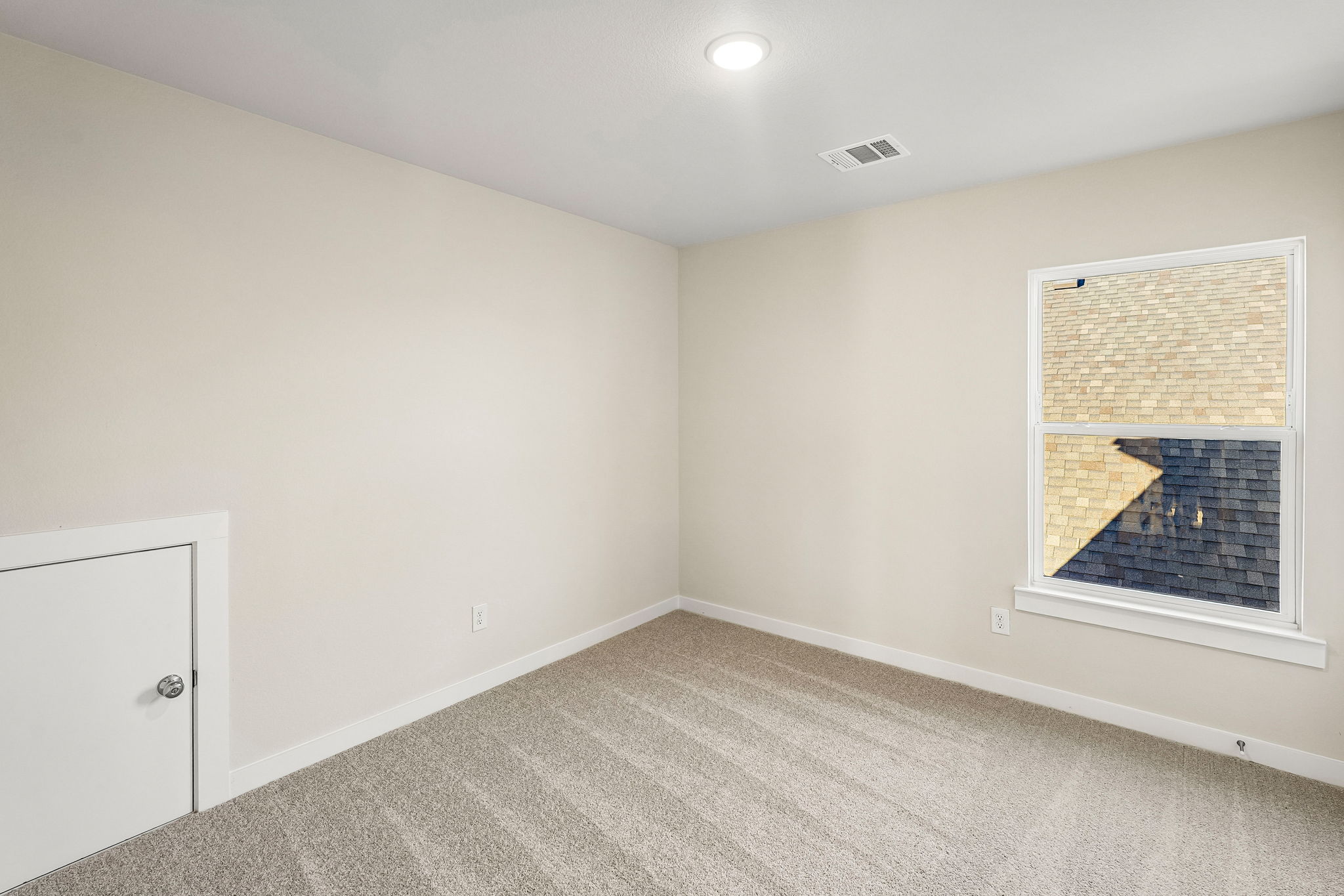 A room with a window and a door.