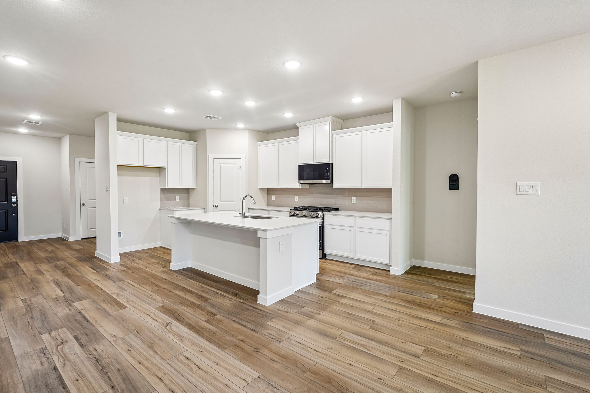 A kitchen with white cabinets.